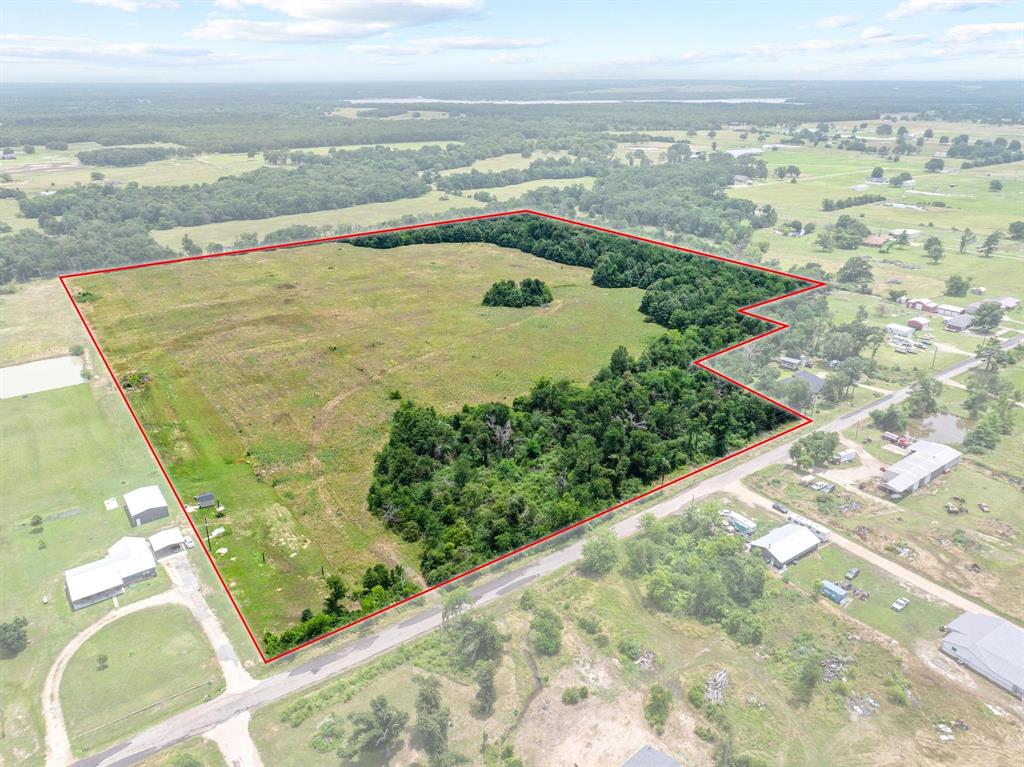 Hard to find acreage North of Paris TX in Lamar County. This 31+ acre tract offers paved CR frontage, coop water and electric, ag exempt and no restrictions. Good native grasses, rich soils, and ready for hay production, livestock, or building your dream home. Mosty open fenced pasture with trees along the front for seclusion. Located in the rural community of Caviness and just a short drive to Paris. Buy, build, invest and enjoy the country.