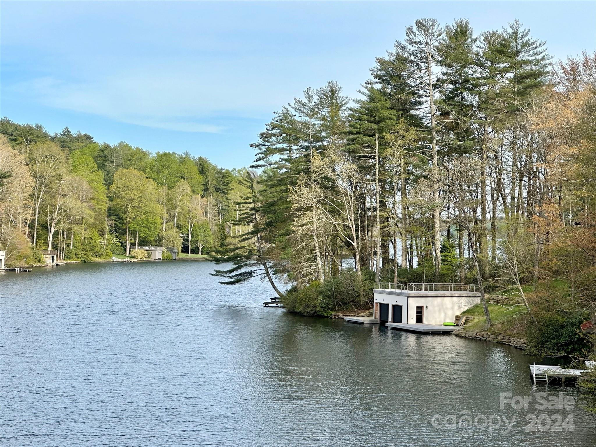 Absolutely magnificent and rare gentle lakefront lot with sweeping views from dam to dam on Lake Toxaway.  Conveniently located on North Club Boulevard near the Club, Greystone Inn, Marina, and Golf Course, this gentle .84 acre site features approximately 185 feet of lake frontage, a spectacular building site, two docks, and one of the nicest settings on the entire lake. This site is the perfect place to create your new lakefront home with gentle drive and flat backyard.