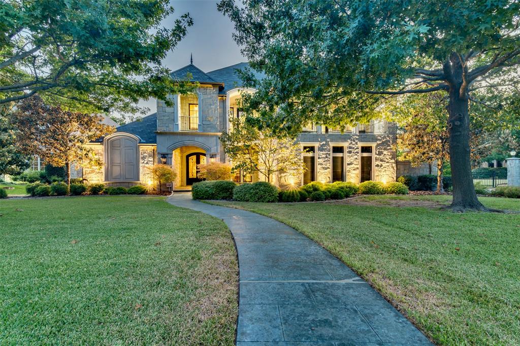 With an extraordinary level of custom craftsmanship and detail, a showstopping resort style backyard retreat, and .71 acres backing to a wooded greenbelt and miles of trails in 400 acre Breckinridge Park, this Park Place Homes estate makes an unforgettable impression in the premier gated Richardson neighborhood of Cantera. Cathedral ceilings with architectural beams, rich hardwood floors, solid wood millwork, and elevated design create remarkable character throughout.  Two oversized islands anchor a kitchen designed for gathering, conversation, and effortless entertaining, with quartz countertops, Wolf range, built in Sub Zero refrigerator, pot filler, warming drawer, 2 beverage refrigerators, and bar with wine fridge. With 6,184 SF, 4 bedrooms, 4 full and 2 half baths, and a 4 car garage, the flexible floor plan includes a downstairs Primary Suite, second bedroom, Office, and Media Room. Upstairs, 2 bedrooms, Game Room, Bonus Room, and 2 covered balconies provide flexibility for guests, hobbies, and quiet retreats. Built on 71 piers extending to bedrock, the home also features 4 tankless water heaters, radiant barrier, and EV ready garage outlet. Outside, the pool and spa, waterfall, gas fire bowls, nature view, and fire pit make every day feel like an escape. Expansive covered patios offer true outdoor living for lounging and dining, with a built in grill and outdoor half bath. Located in Plano ISD with an elementary school within walking distance, easy access to US 75 and George Bush Turnpike, and shopping and dining minutes away. From quiet mornings overlooking the trees to evenings gathered around the pool and fire, every part of this estate is designed to make life at home feel exceptional, creating a lifestyle that stands apart even within Cantera.
