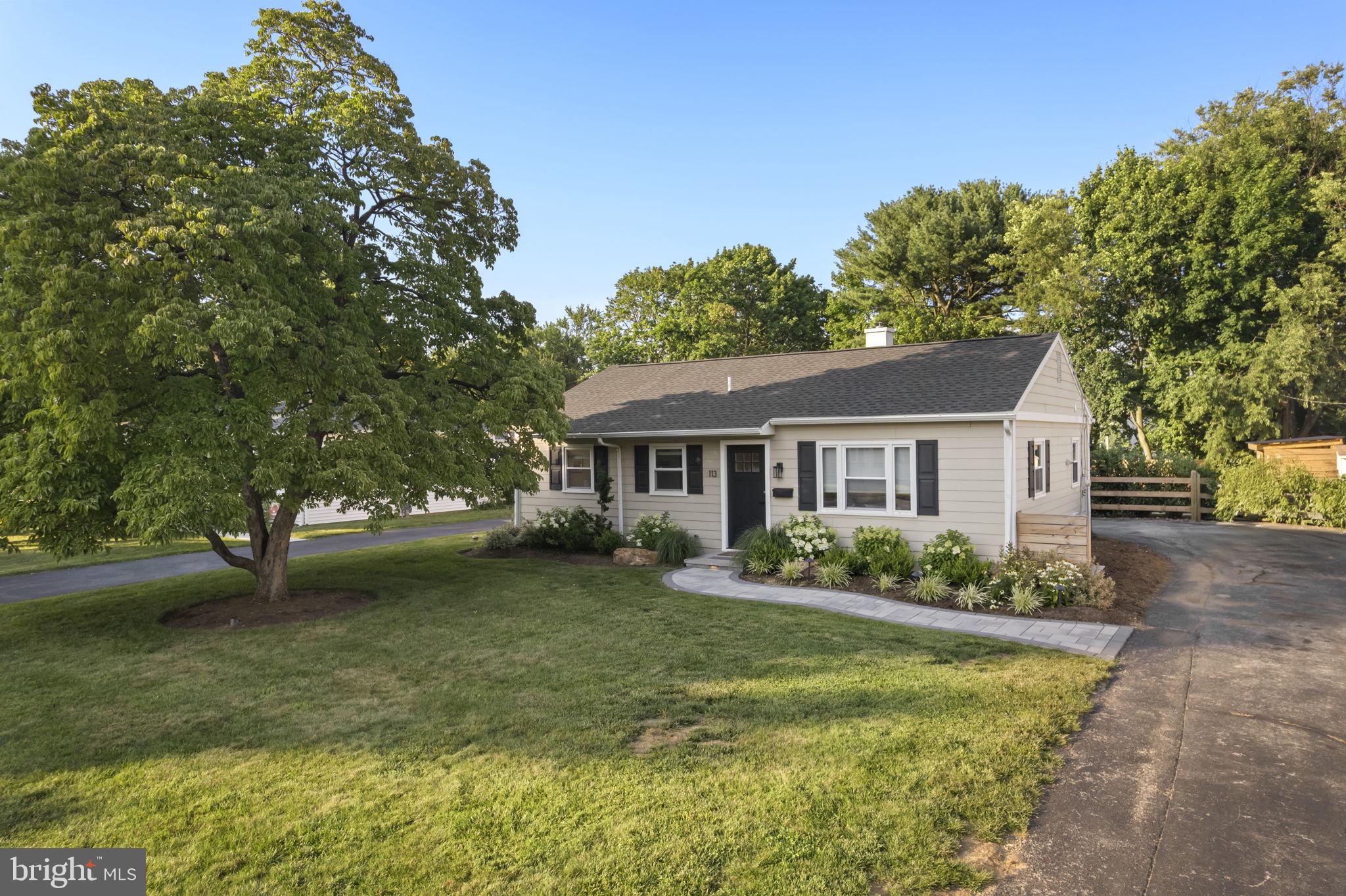 Beautifully renovated and thoughtfully expanded, this picture-perfect ranch-style home is nestled in sought-after Paoli Gardens, combining the ease of single-story living with incredible convenience and a tasteful, neutral palette throughout. Set back gracefully from the road with attractive landscaping, the home features a lovely stone walkway from the side driveway. Inside, an oversized picture window drenches the front living room in natural light. Steps away sits the updated kitchen with shiplap wall, granite countertops, a farmhouse sink, peninsula seating and a convenient side entrance to the driveway. Floor-to-ceiling custom cabinetry provides valuable pantry and mudroom storage, keeping essentials neatly concealed and organized. The kitchen flows seamlessly into an expansive rear family room—part of an earlier addition—where vaulted ceilings create an open, airy feel. This versatile gathering space easily accommodates a lounge area and large dining table, making it ideal for daily living and entertaining. From there, glass sliders open directly to the backyard for an effortless indoor-outdoor connection. Tucked away on the other side of the main level you’ll find three sunny bedrooms and a full hall bath, offering a peaceful retreat from the main living spaces. Outside enjoy a spectacular backyard oasis anchored by an impressive stone patio with outdoor fireplace, mantel and television mount above—perfect for cozy evenings and game-day gatherings. An outdoor kitchen with built-in grill, beverage refrigerator, storage drawers and countertop seating for four makes entertaining a breeze, while a separate dining area accommodates additional guests. Beyond the patio, a generous stretch of flat, fenced greenspace offers plenty of room to roam, garden and play, complemented by a convenient storage shed. Popular scenic spots like Friendship Park, Paoli Battlefield Historical Park and Fox Hollow Trail are mere minutes away, along with commuter rail and shopping necessities including Wegman’s, Target and a newer Trader Joe’s. Homes in this friendly neighborhood are zoned for Great Valley School District, bringing incredible educational opportunities to your doorstep. Don’t miss this chance to enjoy turnkey living in one of area’s most desirable communities!