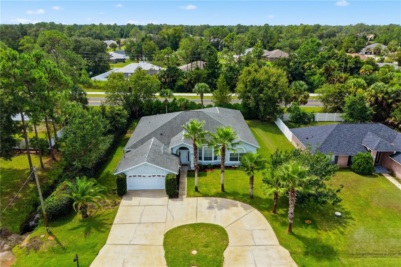 Welcome to 19 Wheatfield Drive—a truly unique and spacious home offering an impressive 3,348 square feet of living space under heat and air and 3,906 total square feet under roof! Designed with generously sized rooms and plenty of space for entertaining, this home features a formal living room, formal dining room, family room and breakfast nook. The open and inviting kitchen overlooks the breakfast area and family room, creating a comfortable central gathering space.The split-bedroom floor plan provides privacy, with spacious secondary bedrooms and an exceptionally large primary suite. The primary bathroom features dual vanities, a soaking tub and a separate walk-in shower.One of this home’s most remarkable features is the enormous game and entertainment room, cooled by its own dedicated A/C system. This one-of-a-kind space includes an additional kitchen, pool table and electrical service for a future spa or hot tub—perfect for entertaining, recreation, multigenerational living or creating your own private retreat. Outside, enjoy a beautiful paver patio overlooking the private, professionally landscaped backyard. A circular driveway adds convenience and impressive curb appeal. Luxury vinyl plank and tile flooring throughout make the home both attractive and easy to maintain. Roof and main A/C installed in 2015; water heater installed in 2022. This extraordinary home offers incredible square footage, versatility and features rarely found at this price—schedule your private showing today