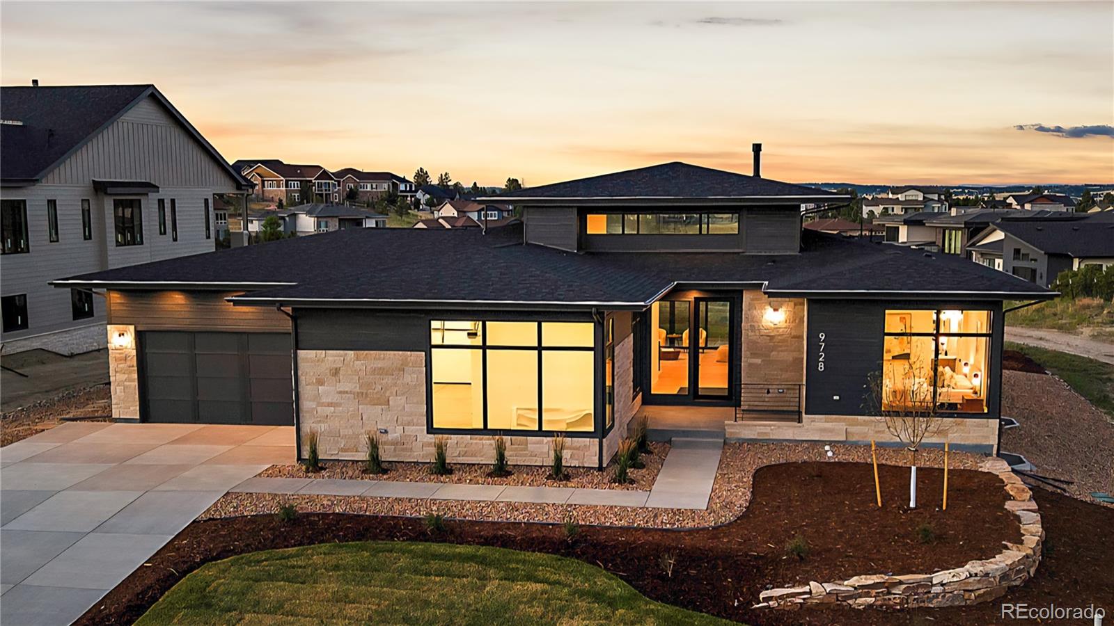 Mountain contemporary masterpiece by Joyce Homes in the sought-after Timbers at the Pinery, offering luxury Colorado living on a tranquil, wooded homesite surrounded by pines, rolling hills, and miles of community trails. Thoughtfully designed, this ranch-style home blends warm modern finishes with expansive windows that frame the natural setting and fill the interior with inviting light. The main level features an open great room with fireplace and seamless flow to a large covered outdoor living room, creating an ideal space for year-round entertaining and everyday relaxation. A gourmet kitchen anchors the heart of the home with a generous center island, custom cabinetry, walk-in pantry, and convenient back kitchen perfect for serious home cooks or catered events. The dining area opens to both the kitchen and patio for easy indoor-outdoor living. The owner’s retreat enjoys main-floor privacy with a spa-inspired bath, oversized shower, soaking tub, and spacious walk-in closet. A dedicated study off the foyer is ideal for working from home, while a main-floor guest suite, laundry room, mud area, and oversized 3 stall garage provides room for all of your gear. The finished lower level is designed for fun, featuring a large rec room, game room, full wet bar, and additional bedroom suites for family or guests, along with excellent unfinished storage and room for future expansion.  A full four-season landscaping package is installed and included in the price, showcasing thoughtfully designed outdoor spaces that complement the architecture and maximize curb appeal. Timbers at the Pinery is one of Parker’s premier custom home communities, offering a secluded feel yet located just minutes from downtown Parker, top-rated Douglas County schools, golf, and convenient commuter routes. Residents enjoy abundant wildlife, serene evenings, and a connection to Colorado’s natural beauty, while benefiting from modern conveniences, nearby shopping, dining, and recreation options.