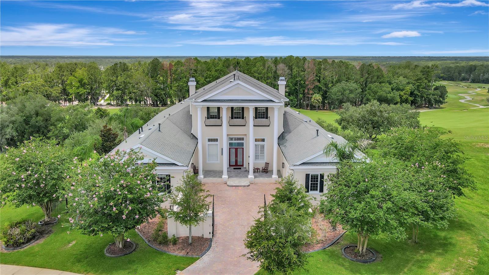 GRAND SUMMIT says is all! Rolling hills and stunning long range views...you will forget you are in Florida!! Known as the largest home and sitting on the highest peak in Southern Hills...this IMPRESSIVE, IMMACULATE, UPGRADED, WELL-CONSTRUCTED, SMART HOME with infinity pool is in mint condition and offers the best views in Southern Hills looking over the 18th hole of the Pete Dye Golf Course! Endless terrace balconies offer the same INCREDIBLE RARE VIEWS as the Clubhouse!! This home regularly gets confused for the Clubhouse! The home has 3 levels with a total of 5 bedrooms + 5 full bathrooms + 2 half bathrooms + heated infinity pool! Enter through your Private Gated Courtyard Entrance with beautiful brick-pavers and TWIN 2-car, side-entrance garages with extra high-ceilings; 4 garage spaces. Your GRAND two-story entrance will tease your senses as you enter into the foyer of the home! Enter the main level and enjoy your gourmet chef's kitchen with a true butler's pantry, walk-in pantry, large breakfast bar and island, upgraded appliances, 2 dishwashers, double ovens, warming drawer, 5-burner gas stovetop, high-end cabinets and granite counter tops! Your kitchen in open to the family room with STUNNING VIEWS from all the large sliders and windows and access to the terrace balconies to have breakfast and sip your coffee in the mornings, entertain your family and guests, or watch the sun go down as you unwind from your day! Also on the main floor is the formal living room, formal dining room, laundry room, wine cellar, 3 bedrooms, 2 full bathrooms, and half guest bath. One of the bedrooms on the main floor can be used as master bedroom with sliders to the terrace balcony and an ensuite bathroom. Head upstairs to the true owner's retreat! See the most incredible views overlooking the 18th hole without even getting out of bed! The master suite has its own siting TV area and wet bar with sink and beverage cooler to make your coffee or drinks right in your bedroom. Open your sliders to the top terrace balcony, private to the master suite, and you see the views that rival the views of the clubhouse!! The master ensuite bathroom is impressive by itself with large walk-in shower with chandelier, frameless glass, multiple shower heads/body pressure heads. It also offer double vanities, sinks and a large walk-in closet! Head to the bottom floor and enjoy the large bedroom/living room with slider to the lanai complete with tongue-and-groove ceilings and its own gas fireplace. You also have two full bathrooms (one is pool bath) + half bath + theater room with stadium seating, gym, and a hidden safe room that is more like a safe house. The safe room has a living room + a full bathroom, large flex room (office/game room/living room), refrigerator, and houses the "brains of the home". The smart home is encrypted for security and offers security cameras everywhere. You can control every light to fan with your finger tip! Full home generator. New doors and sliders. No wood trusses between floors, each level is a poured solid a concrete slab! Southern Hills Plantation is a highly-desired and admired, gated golf community just 40 minutes north of Tampa Bay offering a community pool/heated spa, fitness center, pro golf shop, full restaurant and bar, tennis courts, spa services, fitness classes & community events!  Be proud of where you live!