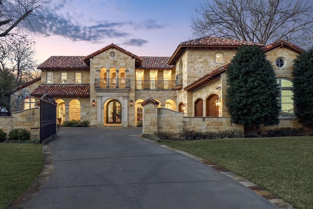 Located on a beautifully landscaped, gated lot of approximately 0.622 acres in coveted Old Preston Hollow, this Mediterranean-style estate offers exceptional scale, privacy, and resort-style living. The expansive 108' x 249' lot features five bedrooms, six full baths, three half baths, and a three individual bay car garage with motor court.The main level is designed for elegant yet functional living, with an open, flowing floor plan that accommodates both formal entertaining and everyday comfort. Spaces include refined formal living areas, a private library or office, a formal dining room and multiple interconnected gathering rooms.The gourmet chef’s kitchen serves as the heart of the home, highlighted by dramatic 21-foot ceilings, commercial-grade appliances, an oversized island, and a full bar with a wine room. It opens seamlessly to the keeping room and family room, creating a natural hub for entertaining and daily living.The first floor includes the primary suite and a guest suite, all with en-suite baths. The primary retreat offers a private sitting room with fireplace, dual spa-like bathrooms, and two expansive walk-in closets. Upstairs, three additional en-suite bedrooms are joined by a large game room with private balcony and a dedicated fitness room.Outdoor living is a standout feature, with approximately 2,000 square feet of covered spaces, multiple terraces, and two covered patios. The resort-style backyard includes a pool with tanning ledge, spa, fountain, and multiple water features. Heat lamps extend year-round usability in the covered patio, while 12-foot holly hedges provide complete privacy with no sightlines from neighboring properties. This is a rare opportunity to own a private estate in one of Dallas’ most prestigious neighborhoods.