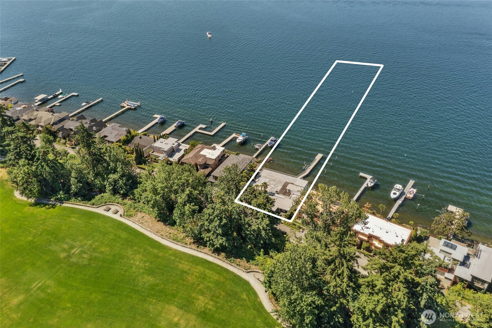 Experience premier Northwest waterfront living on one of Kirkland’s most coveted streets. This level 1.24-acre estate offers magnificent, sweeping southwest views of Lake Washington, Seattle, Bellevue, Mount Rainier, the Olympics, year-round sunsets & never-ending maritime performances. 2,780SF mid-century 3BR, 2.5BA home w/floor-to-ceiling windows, spacious living/dining/family rooms, full-width deck, & upper-level primary suite w/balcony. 99’ of prime frontage, 100+ ft dock & a mature palm tree grove! Renovate or build an expansive custom home w/stunning vistas from every room. A short stroll to vibrant downtown Kirkland’s shops & chef inspired restaurants, this is your opportunity to own a generational property on Kirkland’s gold coast.