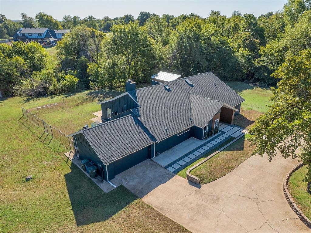 RARE FIND IN HIGHLY SOUGHT-AFTER EDMOND NORTH HIGH SCHOOL DISTRICT! NO HOA, 2.25 WOODED ACRES & A 24x36 SHOP! Opportunities like this are hard to find! Nestled among mature trees, this stunning 3,100 sq ft interior designer/builder’s personal home offers the perfect blend of privacy, luxury, and convenience—just 3.5 miles from major shopping and freeway access!Step inside to discover designer finishes, 4 bedrooms, 3 full baths, beautiful hardwood floors, and a completely remodeled kitchen featuring quartz countertops and a spacious eat-at island. The generous formal dining room is perfect for entertaining, while the living room features a gas log fireplace and dramatic loft overlooking the space. A second living/playroom provides flexibility. A mudroom with backpack hutch adds everyday convenience. The bar/butler’s pantry includes a beverage refrigerator and undercounter ice maker. The luxurious primary bath features heated tile floors, and quartz window sills add another custom touch throughout.One of this home’s most unique features is the fully finished shipping container addition, transformed into a spacious primary closet and laundry room! Fully insulated, sheetrocked, and structurally engineered with documentation approved during the City of Edmond permitting process, it’s a must-see design feature!MAJOR UPDATES & EXTRAS: NEW HVAC (2026), NEW ROOF (2025), freshly repainted exterior, updated bedroom paint, whole-house natural gas generator (serviced 2026), aerobic septic system, in-ground storm shelter, powered 24x36 SHOP, additional storage shed with a treehouse above, and custom concrete paver entry.Enjoy peaceful acreage living without sacrificing location, all within the Heritage Elementary, Sequoyah Middle, and Edmond North High School boundaries. NO HOA, ROOM TO ROAM, AND A SHOP—ALL IN EDMOND NORTH! A truly one-of-a-kind property you must experience in person!