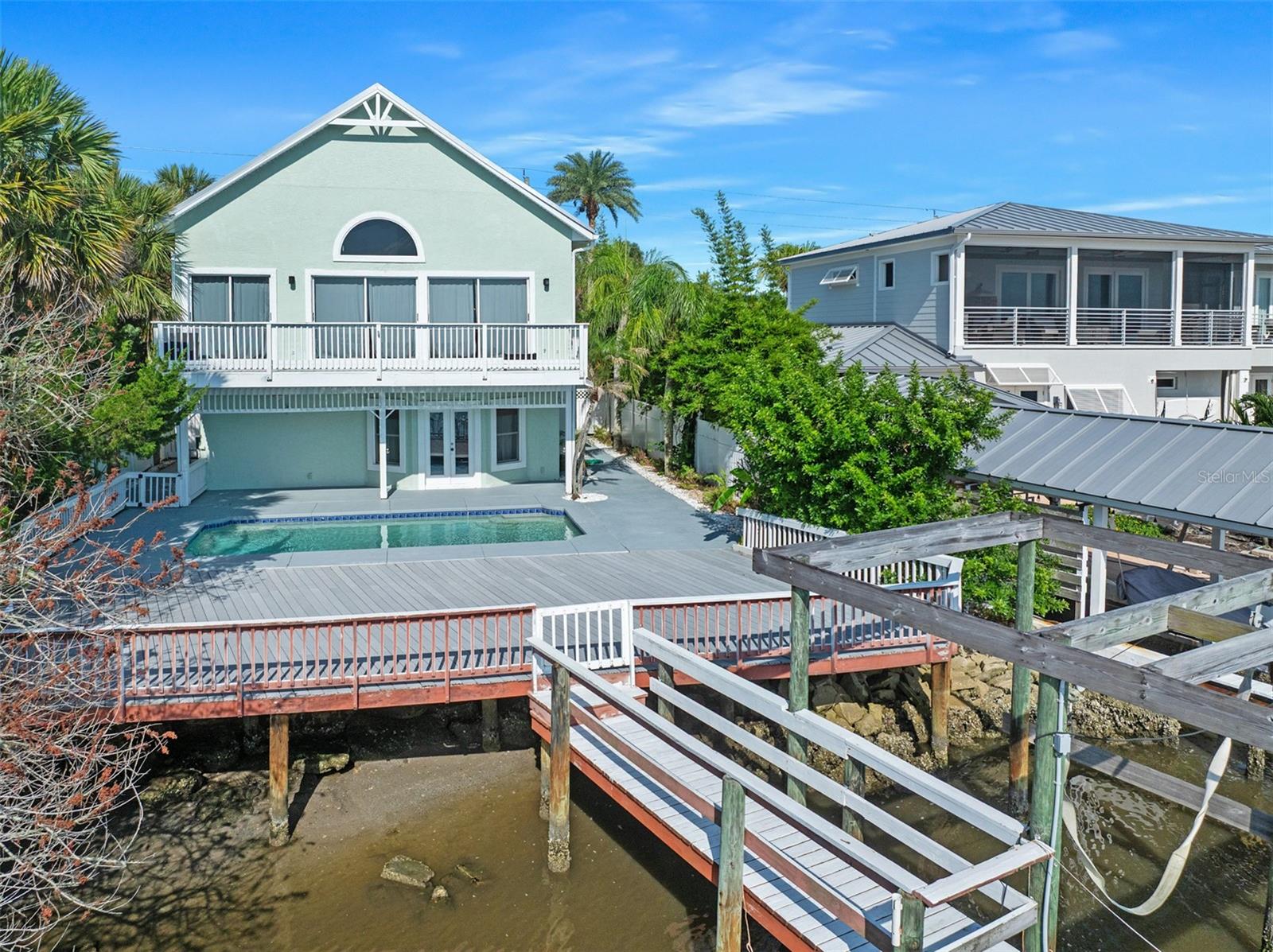 Price improvement AND $15,000 seller concession at closing. DIRECT WATERFRONT with DOCK! Live the Florida waterfront lifestyle in this exceptional 3-bedroom, 3-bath home on desirable John Anderson Drive. Designed for both everyday living and entertaining, the open-concept main level features soaring ceilings, abundant natural light, expansive sliders, and beautiful water views. The spacious kitchen flows seamlessly into the living and dining areas, with the primary suite and guest bedroom conveniently located on the main floor. Downstairs offers a second living area and a third bedroom with built-in bunk beds, creating the perfect private retreat for guests or family. Step outside to your tropical oasis featuring lush landscaping, an expansive entertaining deck, sparkling pool, and private dock with direct water access for boating, paddleboarding, kayaking, or fishing. A rare opportunity to own a luxurious waterfront retreat in one of the area's most sought-after locations. Schedule your private showing today!