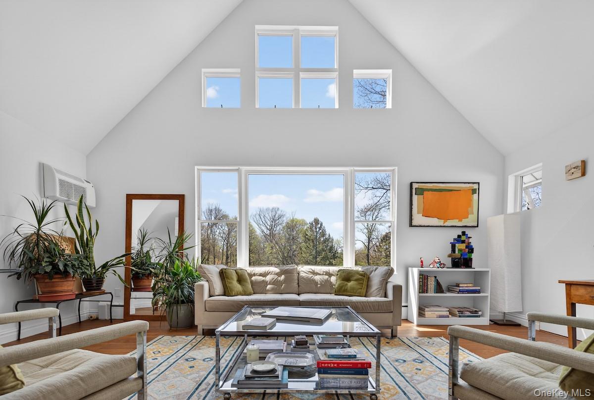 A rare opportunity for outstanding Hudson River views is offered in this distinctive 2-bedroom 2-bath condominium in the heart of Dobbs Ferry. The home is located in Genehurst, a unique 1894 mansion that the Dobbs Ferry Historic Society deemed an official Village Historic Home! Its old-world charm includes authentic moldings, stained glass windows, and wood wall panel details, all restored to their turn-of-the-century magnificence to be enjoyed as you proceed through the building. Enter the unit to find a vestibule glistening in southern sunlight from double skylight windows framing the sky. From here, rich hardwood floors extend throughout the home, creating a unifying element that connects all the spaces. Gorgeous evergreens and glimpses of the Palisades lure you into a gracious gabled living room with 15-ft. ceilings and dining area. The prominent picture windows literally reach to the sky, displaying mature woodlands by day and fabulous Hudson Valley sunsets at dusk. Morning sun floods into a cheerful main floor bedroom with 15'8" ceilings and deep walk-in closet. Glorious green hills are revealed all the way to the horizon through a series of large eastern-facing casement windows. A sunlit modern kitchen with white quartz counters and top-of-the-line appliances is beautifully designed with efficient use of storage space. A hall bath and concealed laundry alcove complete the main floor. Enjoy a very special private primary suite on the upper level, where a generous sitting room loft overlooks the living room whose upper windows showcase the woodlands vista. Swimming in sunlight, discover the primary bedroom with peaked ceiling to 12-ft. Its series of skylight windows offer treetop views and extraordinary evening sunsets. A luxurious gabled bath is cleverly lit by the sun, with quartz countertop and walk-in glass shower, and multiple walk-in closet areas are neatly integrated into the suite. The home comes with additional bulk storage areas in the basement of the building. Leave your car behind to value the fantastic location: one block from the Old Croton Aqueduct trail, two blocks from the vibrant Village downtown, and three blocks from Waterfront Park and the MetroNorth train. MONTHLY MAINTENANCE INCLUDES HEAT AND HOT WATER! Taxes do not reflect STAR reduction of $1545 for those who qualify. With award-winning schools, come see what a prize this exceptional condominium can be.