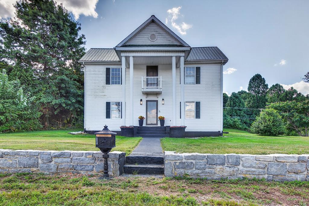 Step into Timeless Elegance — Fully Remodeled Historic. From the moment you pull into the driveway, this beautifully reimagined historic home invites you in with a perfect blend of classic charm and modern luxury. Every inch of this property has been meticulously renovated, from fresh paint and gleaming hardwood floors to brand-new lighting, bathrooms, and a thoughtfully redesigned kitchen. Enter through the spacious mudroom, designed for both style and function, with ample built-in storage to keep life organized. From there, you're welcomed into the heart of the home, a fully updated kitchen featuring all-new appliances, warm butcher block countertops, and elegant chandeliers that bring a touch of sophistication to everyday living. French doors off the kitchen lead to a stunningly remodeled back patio that overlooks a peaceful forested backdrop, a perfect space for morning coffee or evening relaxation. Back inside, the laundry room offers convenience and charm, tucked just off the kitchen. The dining room, flooded with natural light, features another set of French doors that open to a beautifully manicured yard and a picturesque gazebo, ideal for entertaining or simply enjoying the view. Pass through a classic doorway into the cozy living room, where the original fireplace stands in pristine condition, a true centerpiece that ties the home's historic roots to its fresh new finishes. Down the hall, discover the first bedroom and a spacious, spa-inspired bathroom complete with a soaking tub, perfect for unwinding. Upstairs, a spacious bedroom and a generous second living area offers endless possibilities, family room, creative space, or private retreat. The 2nd bathroom features a walk-in shower and yet another spacious closet. At the end of the hall, the upstairs bedroom feels like a private sanctuary, complete with its own balcony overlooking the expansive, tree-lined property. Call today for your private showing. Buyers and Buyer's Agent to verify all information.