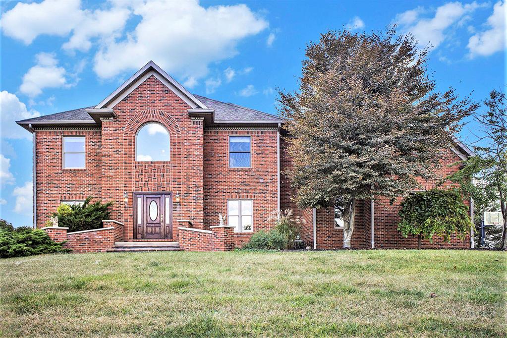 Unique opportunity to own 10 beautiful acres with lake frontage on a chain of 7 lakes. This custom-built home showcases timeless craftsmanship with natural solid wood trim, doors, and cabinetry rarely seen in modern construction. Open-concept main level with scenic views of the land and water. Step outside to a pergola wrapped in grapevines, a natural gas fire pit, and grill area with water feature. Walkout basement offers an antique bar, pool table, full bath with urinal, and a 14x8 safe room. Spacious bedrooms, home office with walnut floors, and gas fireplace with custom mantle. Kitchen features Dutch Maid cherry cabinetry, Sub-Zero refrigerator, Jen-Air cooktop, and slate flooring. Anderson windows, security system, and exterior lighting on timers. Heated and insulated pole barn with drive-in upper level, half bath, and its own well and septic. In-floor heat in basement plus separate furnaces for each level. Waterfront with steel seawall boat well, and pond with fountain.Property Highlights
This home combines the character and quality craftsmanship of an older home with modern luxury and energy efficiency. 
Pole lighting illuminates the long and winding, concrete driveway leading you through the beautiful property to the home itself  an exceptional blend of comfort, design, and practicality.
The property is lined with mature pines and includes wooded areas with scenic walkways, creating a serene and private setting. Paver sidewalks and professionally landscaped grounds showcase stone retaining walls, a water feature, and a stairway that leads down to the walkout basement area.
An impressive 10' x 27' covered patio sits alongside the heated and insulated 37'x 50' pole barn, which includes a half bath, its own well and septic system, and a concrete floor. Ingeniously designed to utilize the natural slope of the land, the barn offers a drive-in second story for maximum
functionality and space.
The walkout basement includes rough plumbing in the wall for a future kitchen or wet bar, offering flexibility for expa