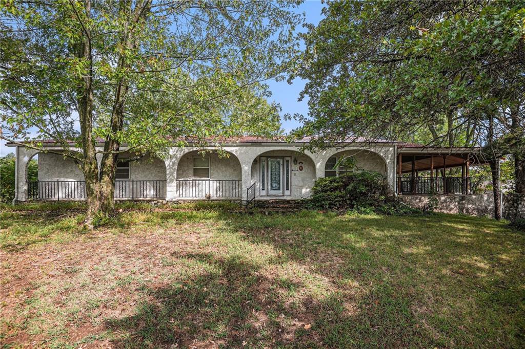 4 bedroom, 3 bathroom ranch home with finished walk out basement on just shy of a half acre lot. Greeted into a large living room with wood burning stove. Living room open to a dining room and kitchen with island, dishwasher, stove, fridge, and laundry hook ups. Primary bedroom with en-suite. 3 additional bedrooms and full bathroom on main level. Lower level hosts a family room, rec room with fireplace, full bathroom, wet bar area, and a storage room. One car garage with entry on back of home. Large front porch. Wrap around covered deck with access from the kitchen and primary bedroom.