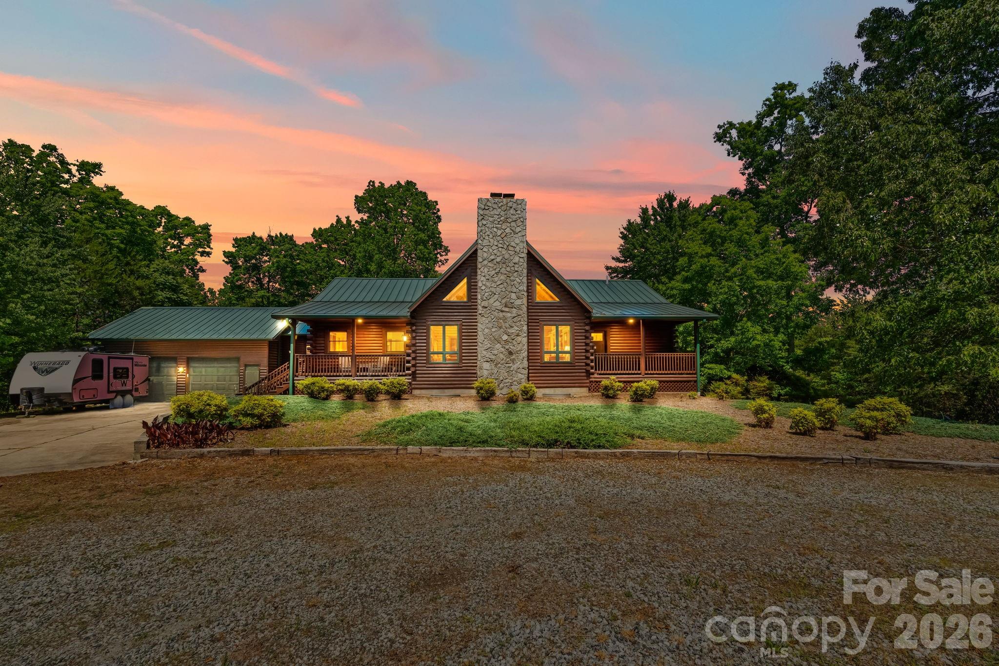 Tryon, NC....Discover a rare 42.92 acre estate offering privacy, space, and versatility just minutes from the heart of Tryon and its renowned horse country. The impressive 6,000 sq ft Southland Log Home welcomes you with soaring 20 ft ceilings, rich hardwood floors and multiple stone fireplaces that create a warm, lodge-like feel. With 5 bedrooms, 3 1/2 baths and 2 full kitchens, this property is perfectly suited for multi-generational living, guest or in-law quarters, or an income-producing rental wing. Stretch out and enjoy the land with over 1,200 feet of frontage on Peniel Road, surrounded by rural charm, beautiful homes and equestrian and estate properties. The expansive 42.92 acres gives you room for pastures, trails, gardens or future improvements---an exceptional canvas in a highly sought-after Tryon location. A serious bonus for hobbyists, car collectors, trades or small business owners is the 4,000 sq ft steel warehouse with 14 foot doors, providing outstanding storage and workspace for equipment, RV's, trailers, or a full shop setup. The combination of a grand log residence, substantial acreage, and commercial-grade outbuilding makes this a one-of-a-kind opportunity in Tryon's luxury market. Whether you envision a private retreat, mini-farm, or equestrian estate, this Peniel Road property delivers space, flexibility and the kind of privacy that's increasingly hard to find in Western North Carolina.