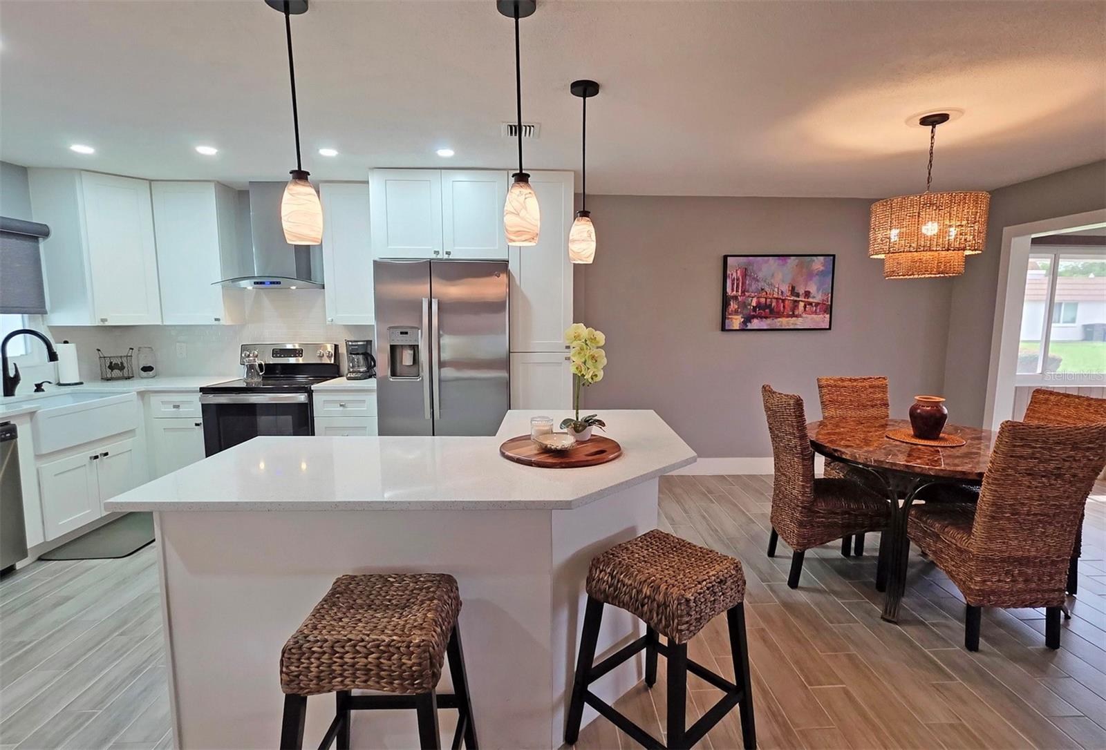 This exceptional residence is truly one of a kind and unlike any comparable property in the community. More than simply updated, this villa has been completely renovated with over $120,000 in improvements and furnishings completed in 2022. Originally intended to be the owner's forever home, no detail was overlooked.This beautifully appointed 2-bedroom, 2-bath split-bedroom villa offers a bright, open floor plan designed for comfortable living and entertaining. The stunning chef's kitchen features custom cabinetry, quartz countertops, a large center island, new stainless steel appliances, and a spacious dining area perfect for hosting family and friends.The expansive living room flows seamlessly into a 344-square-foot Florida room, providing generous additional living space for relaxing or accommodating guests. Throughout the home, you'll find elegant porcelain tile flooring, fresh interior paint, and beautifully renovated bathrooms with new vanities, sinks, toilets, and custom tile surrounds for both the tub and showers.The air-conditioned laundry room includes a new washer and dryer, utility sink, and new electric water heater. Additional major improvements include a new HVAC system, custom blackout shades, barn doors in the guest area, and all-new plumbing from the villa  and laundry room to the street.Built with peace of mind in mind, the home features hurricane-impact windows in the bedrooms and bathrooms, hurricane shutters, and even upgraded flooring in the covered carport. The rear patio showcases attractive new pavers, a barbecue area, and a convenient storage shed.Best of all, this home is being offered turnkey furnished with upscale furniture, kitchen items and linens allowing you to move right in and start enjoying the Florida lifestyle. A complete list of improvements and furnishings is available in the supplements.Located in a private, vibrant 55+ community, residents enjoy access to a protected marina on Philippi Creek featuring 32 boat slips available on a first-come, first-served basis (waiting list may apply). Slips accommodate boats up to 24 feet as well as jet skis, with an annual lease of just $1,344.Community amenities include an on-site manager, clubhouse, fitness rooms, meeting room, and library. The location is exceptional—just minutes from Gulf Gate shopping center, Publix grocery, banking, restaurants, and public transportation. Detwiler's Farm Market is only steps away, downtown Sarasota is approximately 15 minutes away, and world-famous Siesta Key Beach is less than 10 minutes from your door.This remarkable residence must be seen in person to fully appreciate the quality, craftsmanship, and value it offers. Schedule your private showing today. Villa 40 is located in ZONE D  which is the safest area for tropical storms and evacuations. No damage or flooding from 2024 Hurricanes.