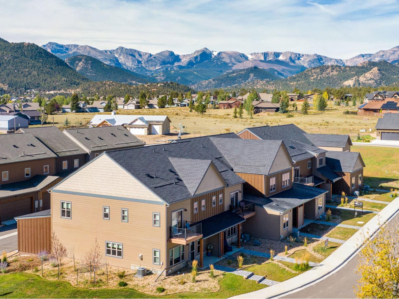 This brand-new construction and low maintenance townhome offers the epitome of mountain living with beautiful upgrades throughout including quartz countertops, solid wood trim and doors, and central air conditioning. Ideal for your next primary residence or second home, this stunning property boasts modern amenities and meticulous attention to detail, showcasing the finest in upscale living. The open concept floor plan on the main level creates an inviting environment for both relaxation and entertaining. All three bedrooms and laundry room are conveniently located upstairs, providing a private and cozy retreat. The spacious primary suite offers a balcony for enjoying the stunning Estes Park surroundings, along with a luxurious bathroom and oversized closet. Residents will appreciate the convenience of the location, providing easy access to the charming town and its array of shops, restaurants, and recreational opportunities. Additionally, the residence features a heated and finished attached two-car garage, ensuring both convenience and security for your vehicles. Easily lock and leave- the HOA takes care of the grounds, exterior maintenance, and exterior insurance. **Amazing loan incentives available from the builder and preferred lender covering origination fees, administration fee, document prep fee, and appraisal fee saving the buyer thousands on closing costs. Let's make your mountain living dream a reality and take advantage of these amazing savings! ** Restrictions and conditions apply, contact for details.
