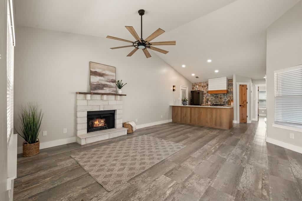 Prepare to fall in love! This is not your average renovation; it's a thoughtfully designed masterpiece. Every detail in this 3-bed, 2-bath home was curated in 2022 to create a space that is both stunningly modern and incredibly warm. As you enter, you are greeted by durable and beautiful Luxury Vinyl Plank (LVP) flooring that flows seamlessly throughout the entire home. The open-concept living space features sleek, flat-textured walls and is anchored by a stone fireplace, creating a warm and inviting focal point. The heart of this home is the magazine-worthy kitchen. A vibrant, Mediterranean-inspired tile backsplash provides a stunning backdrop for the warm white oak cabinets, quartz countertops, and custom-built, shiplap range hood. A private primary suite offers a tranquil retreat with an updated en-suite bathroom. Two additional bedrooms provide flexibility for family or a home office. Complete with an attached one-car garage, this home's location within the acclaimed Keller ISD makes it a truly exceptional find. Convenient access to highways, shopping and dining!