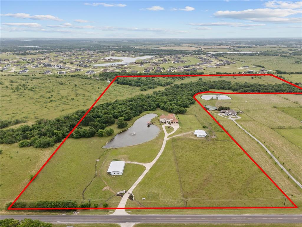 Bring the Longhorns, Bring the horses!Welcome to Fisherman's Lake Ranch!Set on 64 fully fenced acres just 30 min from Dallas, this private gated ranch offers a rare balance of seclusion and accessibility. A large, stocked fishing lake with covered gazebo, along with two stock tanks provides beauty and function for livestock and recreation.Equestrian facilities are thoughtfully designed with a six-stall fully equipped barn, wash bay, tack room, bathroom and an office. Separate event center and bunkhouse living quarters with 3 bedrooms, a full kitchen and an expansive game area, Ideal for extended guest quarters.   This could be a venue for so many uses, including parties, conference center, meeting Western Weddings, and with this fully equip kitchen you can feed hundreds.The land is rich with quail, native wildlife, deer and more, creating a true Texas experience.900-ft. concrete drive leads to the impressive main residence offering refined craftsmanship that set the tone.  Walls for trophies plus that longhorn rack. Built for comfort and entertaining, soaring ceilings, rich burl wood, a grand fireplace, and large chefs' kitchen for gathering. Baths offer quartz, counters and each bedroom have a private bath. Elevator for those who desire total luxury.  The main bedroom has a fireplace and two double doors opening to your private balcony where you can overlook this estate. Game room sports a wet bar, room for a pool table, a safe room and wall of build ins. Oversized office sports 2 individual desk areas and wall of bookcases. This area overlooks an oversize pool.Outdoor living is exceptional with one of the largest entertain areas in the region. Enjoy a resort style pool with swim up bar, tanning ledge water features and expansive covered patios for year-round entertaining fireplace, full kitchen area for outdoor living.This remarkable 64-acre ranch captures the essence of Texas living, with the added benefit of future development.