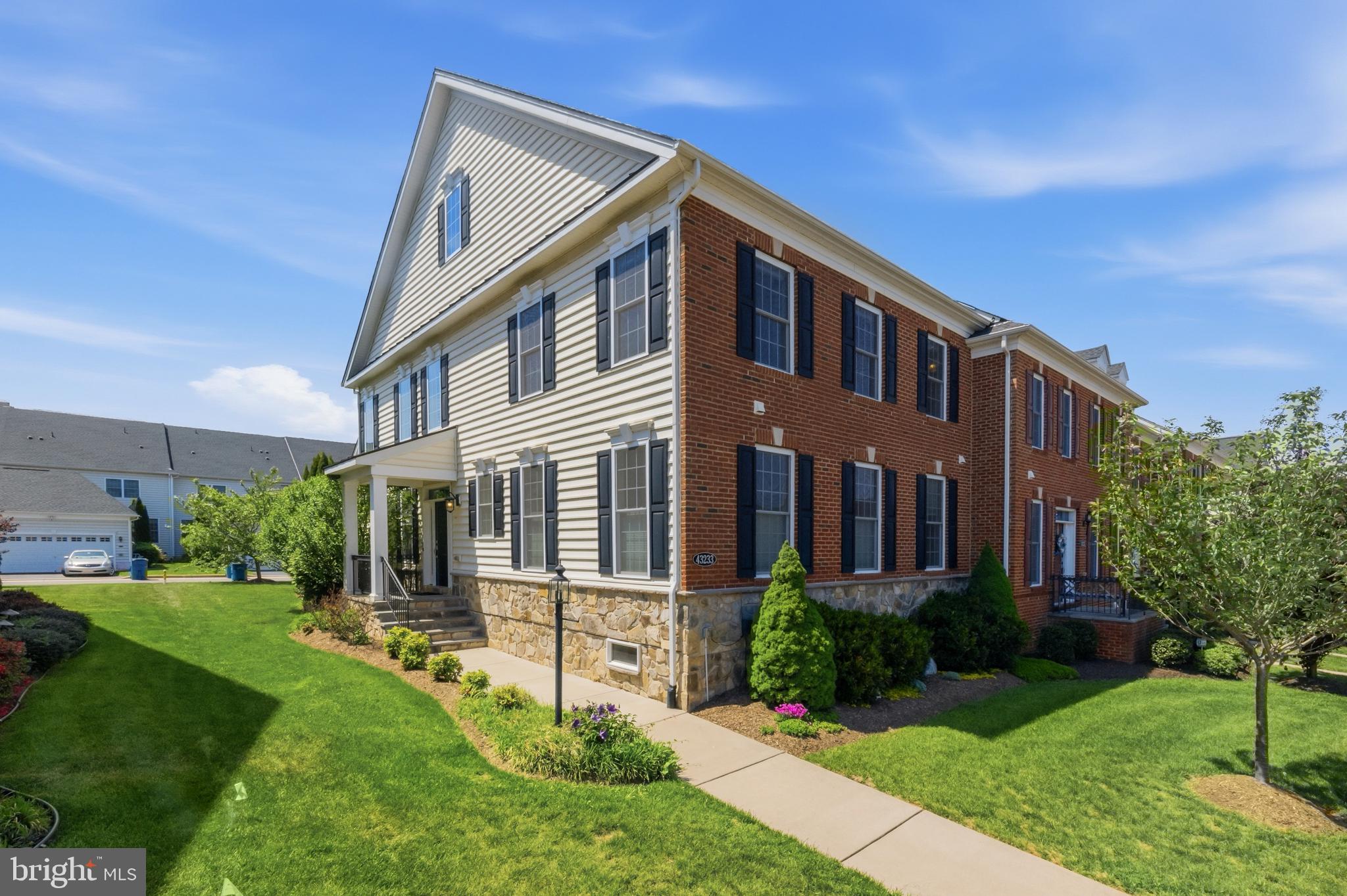 43233 Hattontown Terrace is a Toll Brothers Norris model in Ashburn that stops you at the door. The two-story great room, statement chandelier, wall of windows with custom plantation shutters, and wide plank hardwood floors tell you immediately that this one was done right.What makes this home genuinely rare is the layout. Two full primary suites, including one on the main level, give this home a flexibility that most homes in this area simply cannot offer. The main level suite features hardwood floors, a walk-in closet, and a spa-caliber bath with an oversized seamless glass shower, Listello tile accent, bench, double sink vanity, and quartz countertops. The second primary suite upstairs has two walk-in closets, dual shower heads, seamless glass, and double vanities with quartz. Both are finished to the same standard.The kitchen is built for real use. An oversized island with counter seating anchors the space alongside white soft-close cabinetry, quartz countertops, glass subway tile, stainless appliances, and a spacious pantry with motion-sensing lighting. A breakfast area connects to a Trex deck with a dedicated natural gas line for the grill. Speakers run through the kitchen, dining room, great room, and deck. A bonus room over the garage with its own private staircase works as a home office, studio, or guest space.The finished basement features a custom wine bar with double wine fridges, glass-front cabinetry, and leather-finish granite, plus a private flex room with a full bath and serious storage throughout. The two-car rear-loading garage includes a 220V EV outlet. An app-controlled inground irrigation system, smart lock, and Ring doorbell are already in place. Lawn maintenance is included in the HOA.Three neighborhood pools and gyms are walkable. Brambleton Town Center, a brand new Target, and One Loudoun with Trader Joe's and dining are a short drive. The Ashburn Silver Line Metro and Dulles airport are both convenient, top-rated Loudoun County public schools serve the area, and Old Farm Winery and Fleetwood Farm Winery are about ten minutes out.