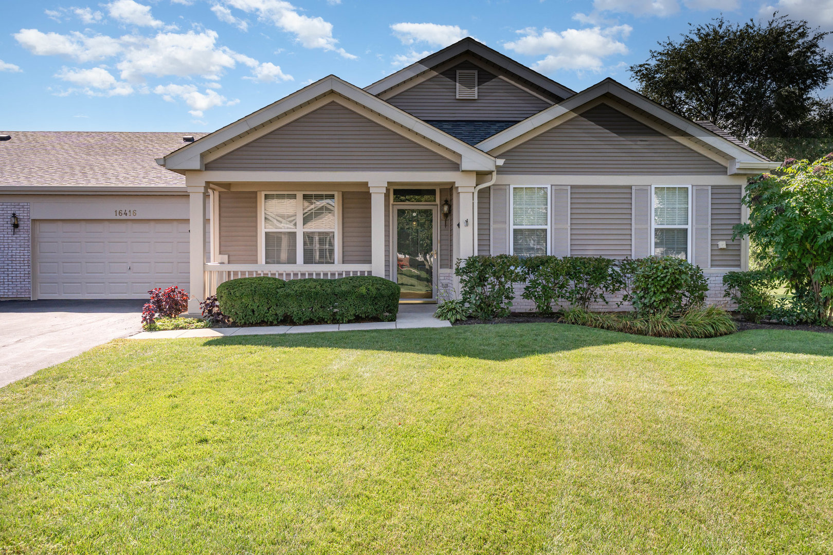 Welcome to the desirable Whitney model in the amenity rich  55+ gated community of Carillon Lakes. Enjoy the convenience of one level living in this attractive 2 bed, 2 bath townhome that's been lovingly maintained. This move-in ready home features an open layout, including a kitchen with new quartz counters, ample cabinets, breakfast bar and pantry. The adjoining dining area offers direct access to a private patio, perfect for relaxing or entertaining. The generous living room, along with both bedrooms, feature brand-new carpeting for a fresh, inviting feel. The oversized primary suite includes a large walk-in closet and a luxurious ensuite bath with dual sinks, soaking tub, and separate walk-in shower. A second spacious bedroom, another full bath with walk-in shower, and a convenient laundry room complete the layout. Additional highlights include ample closet space throughout and an attached 2-car garage for extra storage. Great location inside the community on a cul-de-sac adjacent to green space. Enjoy a low-maintenance lifestyle and resort-style amenities: golf course, tennis courts, walking and biking trails, fitness center, indoor/outdoor pools, exterior maintenance - all with a low monthly HOA!