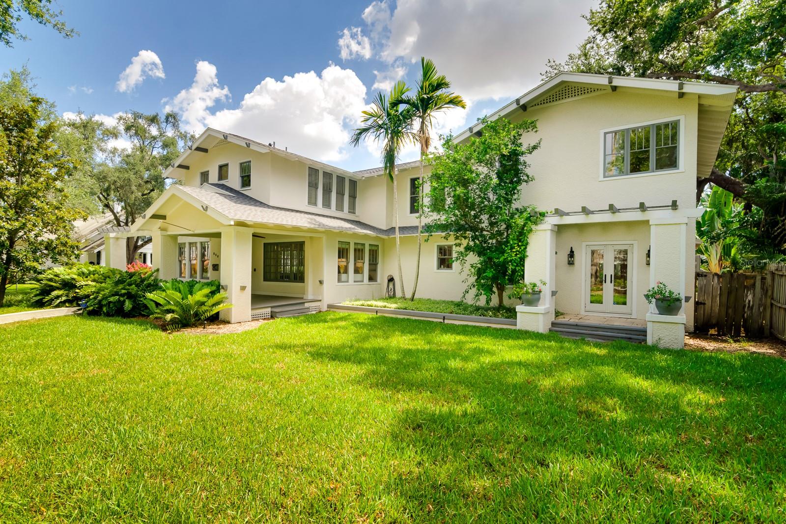 Under contract-accepting backup offers. Just one block from Hyde Park Village’s boutique shops and fine dining, this spacious residence located on an oversized corner lot offers a perfect blend of historic charm and modern upgrades. The heart of the home is a gourmet kitchen with ample cabinetry and counter space, leading to a large family room and covered back porch with an outdoor kitchen and tropical swimming pool—ideal for entertaining. The first floor features formal living and dining rooms, a home office, and a guest bedroom. Wine enthusiasts will delight in the walk-in refrigerated wine room. Upstairs, the expansive owner’s suite boasts a custom walk-in closet and a beautifully appointed en-suite bath. Two more bedrooms, two baths, and a walk-in laundry room complete the second floor. Step outside to a tropical backyard oasis, featuring a freeform pool, stone waterfall, hot tub, and lush landscaping. A detached 2-car garage provides easy car access and includes a 752 sq ft guest apartment above, equipped with a living room, kitchenette, bedroom, and bath. With a total living space of 5,041 sq ft (main house: 4BR/4BA, 4,289 sq ft + guest apartment: 1BR/2BA, 752 sq ft), this home combines luxury, location, and lifestyle in one of Tampa’s most sought-after neighborhoods.