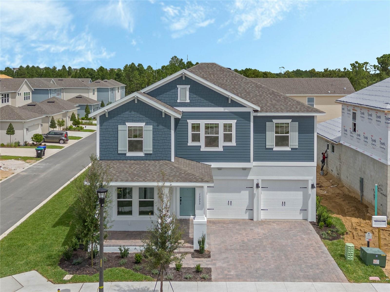 Under Construction. Luxury New Home by RockWell Homes. Experience the ultimate in modern luxury with this stunning new home on oversize home site with room for a pool (lot#130). This spacious 5 bedroom, 4-bathroom design offers the perfect combination of style, functionality, and comfort. The home features a 3-car garage and both a covered front porch and a covered backyard lanai, ideal for outdoor relaxation or entertaining.  The heart of the home is the chef-inspired kitchen, which includes solid surface countertops, an island, and high-end stainless steel gas appliances, such as a cooktop, oven, microwave, and dishwasher. The kitchen also features an undermount sink with a Delta faucet, a beautiful ceramic tile backsplash, upgraded 42-inch cabinets, upgraded flooring, Delta faucet and a huge walk-in pantry, providing ample storage and making it a dream space for any home chef.  The spacious living area is designed with upgraded flooring and enhanced with natural light flowing in through dual-pane energy-efficient windows. These windows offer access to the covered backyard lanai, seamlessly blending indoor and outdoor living spaces.  The private primary suite is a true retreat, featuring dual sink vanities with Delta faucets, ceramic tile flooring, and a luxurious oversized shower with a glass enclosure. Additional features include a lighting package, towel bars, and a huge walk-in closet, offering plenty of storage and comfort.  The secondary bedrooms are generously sized, each with its own walk-in closet and access to separate bathrooms. These bathrooms include ceramic tile flooring, ceramic tile tub/shower surrounds, Delta faucets, lighting packages, and towel bars, ensuring both style and functionality.  Additional features of this exceptional new home include a full sprinkler system, a complete landscaping package, energy-efficient construction, a garage door opener, and a utility area with ceramic tile flooring. The home also boasts an 8-foot front door, a private backyard for added privacy, and a new home warranty for peace of mind.  This luxury new home by RockWell Homes offers a perfect combination of upscale living, energy efficiency, and a beautifully designed layout. It’s ideal for those looking for both style and comfort in their next home.  Quick access to Walt Disney World Theme Parks, downtown Orlando, shopping, dining and Winter Garden.