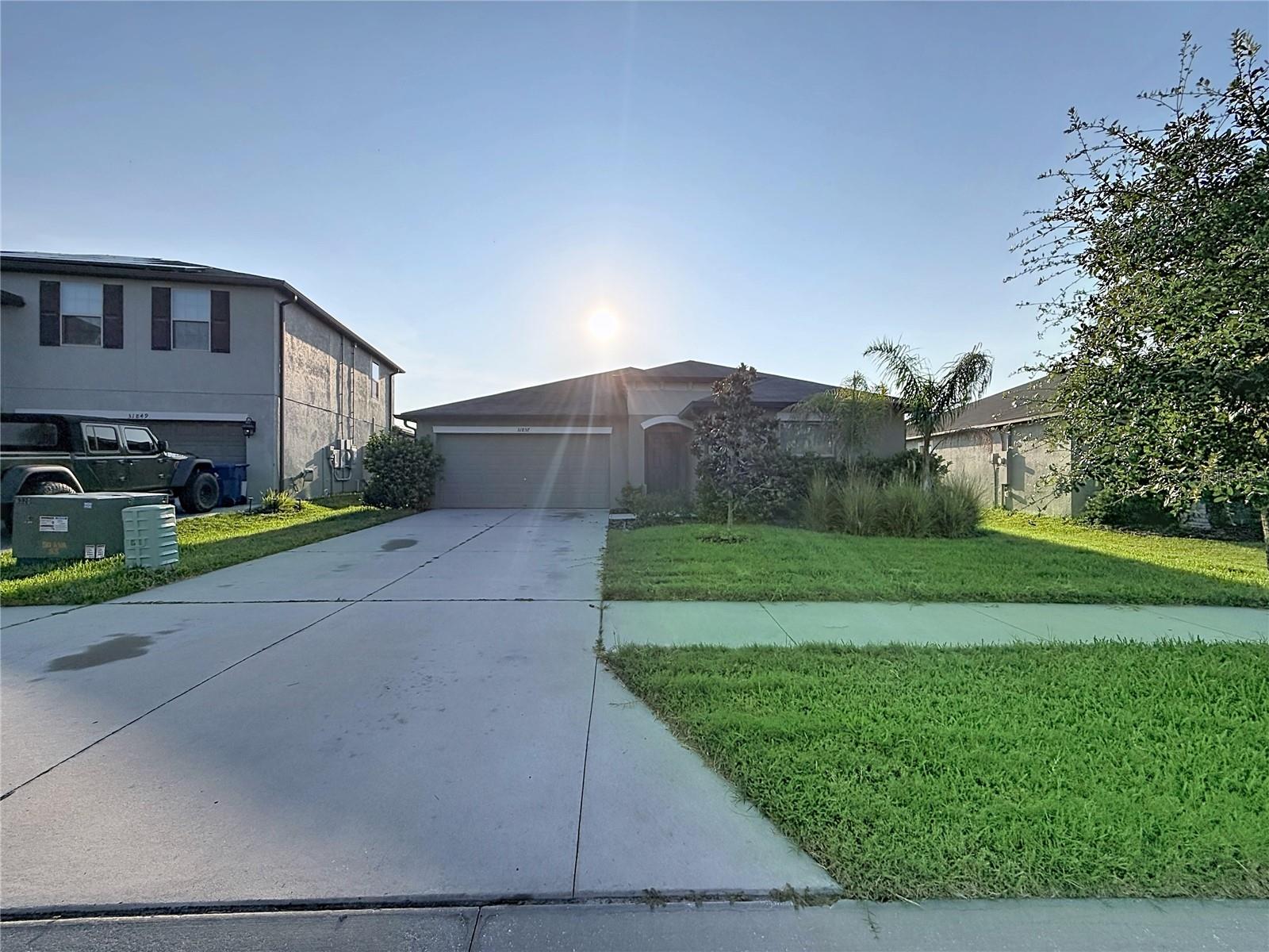 Welcome to this well-maintained 4-bedroom, 2-bath single-family home located in the sought-after Epperson community of Wesley Chapel. Built in 2021, this one-story residence offers approximately 1,936 square feet of living space, an attached garage, and a spacious homesite of approximately 6,900 square feet.The thoughtfully designed floor plan features all living areas on one level, providing convenience and easy accessibility while offering the space and flexibility of four true bedrooms. The open-concept layout connects the kitchen, café-style dining area, and family room, creating a comfortable space for everyday living and entertaining. The kitchen features a large island with additional seating and workspace, perfect for meal preparation, casual dining, or gathering with family and friends.The private primary suite includes a walk-in closet and en-suite bathroom with dual vanities and a separate shower. Three additional bedrooms provide flexibility for family, guests, a home office, playroom, or fitness space. A second full bathroom and dedicated laundry area add to the home's functionality.Enjoy the benefits of single-family living with a larger homesite, attached garage, and outdoor space. Located in the popular Epperson community, residents have access to the iconic Crystal Lagoon featuring a beach-style setting, swimming, kayaking, paddleboarding, water activities, and community events (additional fees may apply for certain activities and amenities). The community also offers parks, playgrounds, dog parks, walking trails, green spaces, and more.Conveniently located near State Road 54 and I-75, this home provides easy access to Publix, top-rated schools, restaurants, medical facilities, Tampa Premium Outlets, The Shops at Wiregrass, and the growing Wesley Chapel area. A great opportunity to enjoy modern Florida living in one of the area's most desirable master-planned communities.