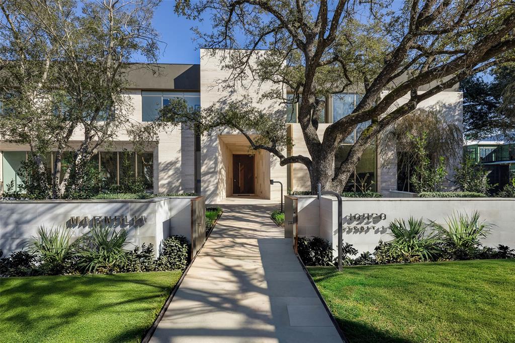 Set on legendary Strait Lane, 10920 is a modern estate that lives like a private resort—11,211 square feet on approximately .72 acres in prestigious Preston Hollow. Behind dual entry gates, clean lines and soaring ceilings create a striking first impression, while floor-to-ceiling custom windows draw in natural light and connect every space to the outdoors.This home is defined by timeless materials and intentional design. Ojinaga limestone and Travertino Jalapa walls establish warmth and texture, complemented by white oak millwork that runs throughout—from custom cabinetry to beautifully finished closet interiors. The open chef’s kitchen is built for entertaining with premium appliances, generous workspace, and a dedicated wine room for effortless hosting. Visual Comfort lighting and statement chandeliers elevate the mood from day to night.A downstairs primary retreat offers a spa-inspired bath with enclosed dual showers and an expansive custom closet with island. Multiple living spaces include formal dining, a sunlit living room with bar, private office with built-ins, media and game rooms, and a main-level guest or staff ensuite. Two utility rooms—one per floor—add everyday ease.Step outside to a covered loggia, outdoor kitchen, pool, and firepit surrounded by mature trees, landscape lighting, and a private backyard sanctuary. A five-car garage and private balconies complete the experience—an exceptional opportunity on one of Dallas’ most recognized addresses.