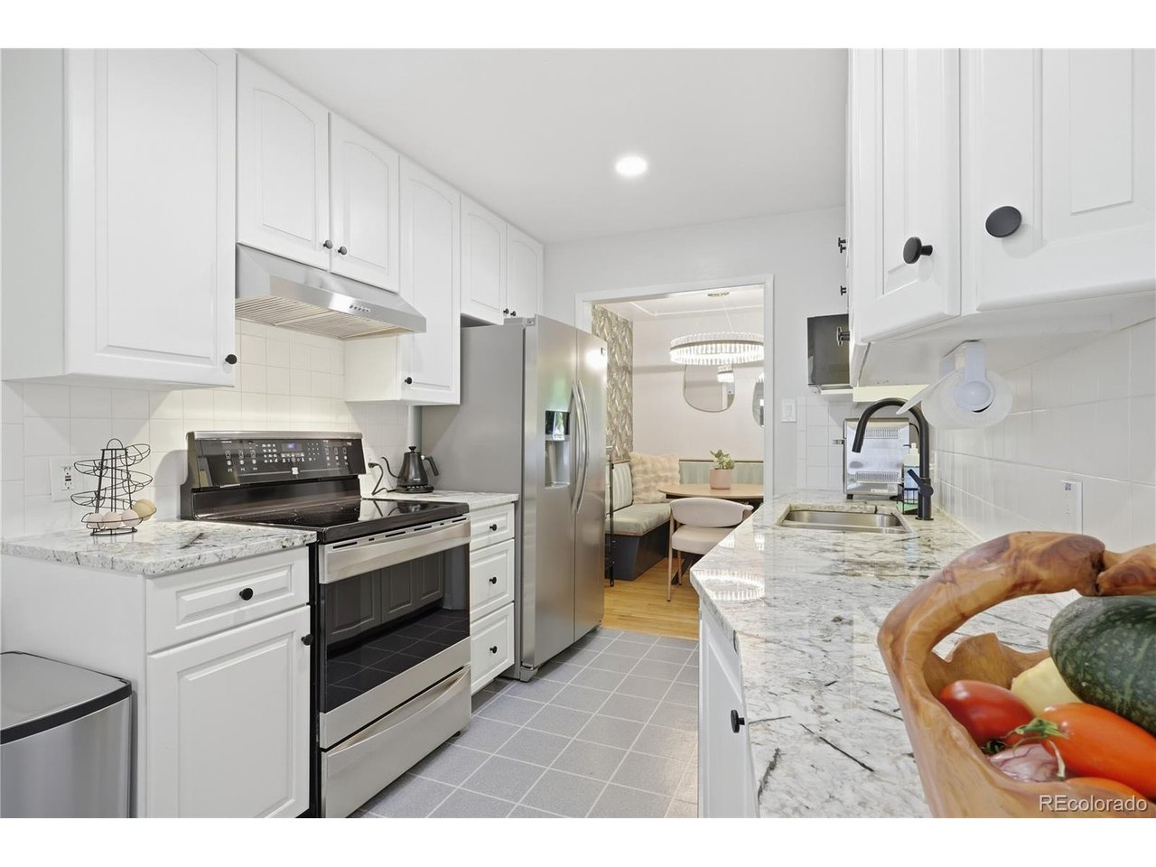 **OPEN HOUSE SUNDAY 9/20 10AM TO 1PM!** Your homestead on the park awaits! This home combines incredible outdoor spaces with sharp interior finishes to create a truly charming and comfortable vibe. Nestled on a large 7,260 square foot lot half a block from Harvey Park, this 1956 brick ranch comes complete with five beds, three updated baths, a beautiful kitchen, and a backyard oasis complete with chicken coop with automatic door (ready for new tenants!), fruit trees, outdoor kitchen/covered BBQ station (with music!), veggie gardens, and an enormous covered stamped concrete patio that will become the centerpiece of your future backyard parties! The main level comes complete with a gorgeous galley kitchen with granite counters, updated cabinets and stainless steel appliances, 3 beds, updated full bath plus a powder room half bath, and original wood floors. Check out the custom banquette! The basement provides additional style and utility, with large wet bar/kitchenette, spacious family room, 2 more nonconforming bedrooms/offices/flex spaces, and a huge laundry/utility room with storage space to spare. The beautifully landscaped front yard features low maintenance, drought tolerant vegetation with built-in irrigation and a cute front porch. Attached 1-car garage plus attached 1-car carport! Solar panels included - paid off! Located just two blocks from Sanderson Gulch trail and half a block from Harvey Park - nearly within rock-skipping distance from the lake! Just a few minutes' walk from the new Harvey Park Farmer's Market and community garden. Come take a look and fall in love!! Call Noah with any questions: 970.420.9531