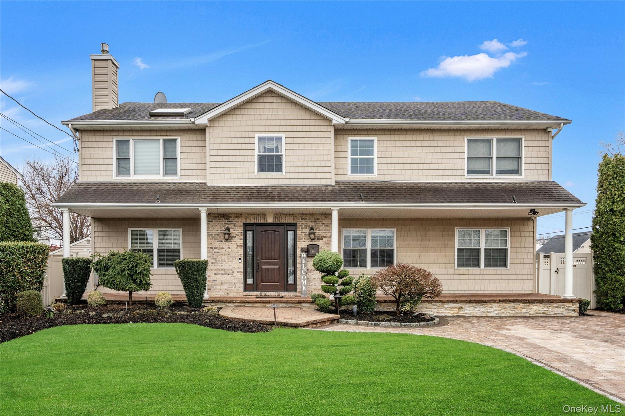 Welcome to this spacious and well-maintained custom built high ranch located on a desirable corner property in Bethpage. Built in 2004, this home features a unique and versatile layout with potential for a mother-daughter setup with proper permits.The upper level offers a living space area with high ceilings, hardwood floors and abundant natural light with skylights. This level features 3 bedrooms with a full ensuite bathroom plus an additional full bathroom.The kitchen is equipped with granite countertops, a center island, stainless steel appliances, a wine fridge, gas cooking and extensive cabinetry. The dining room includes sliding glass doors providing access to the outdoor space. The main level includes a large foyer, 2 bedrooms, 1 full bathroom and 1 additional room currently utilized as office space.The full finished basement is designed for entertaining and includes a modern fireplace with custom cabinetry, tray ceilings, a surround sound system, bar area with a separate entrance.Central air, sprinkler system, security system and cameras, generator hook-up and large covered front porch are just some of the  extras that add to this charming home. Too many upgrades to list. A must see!