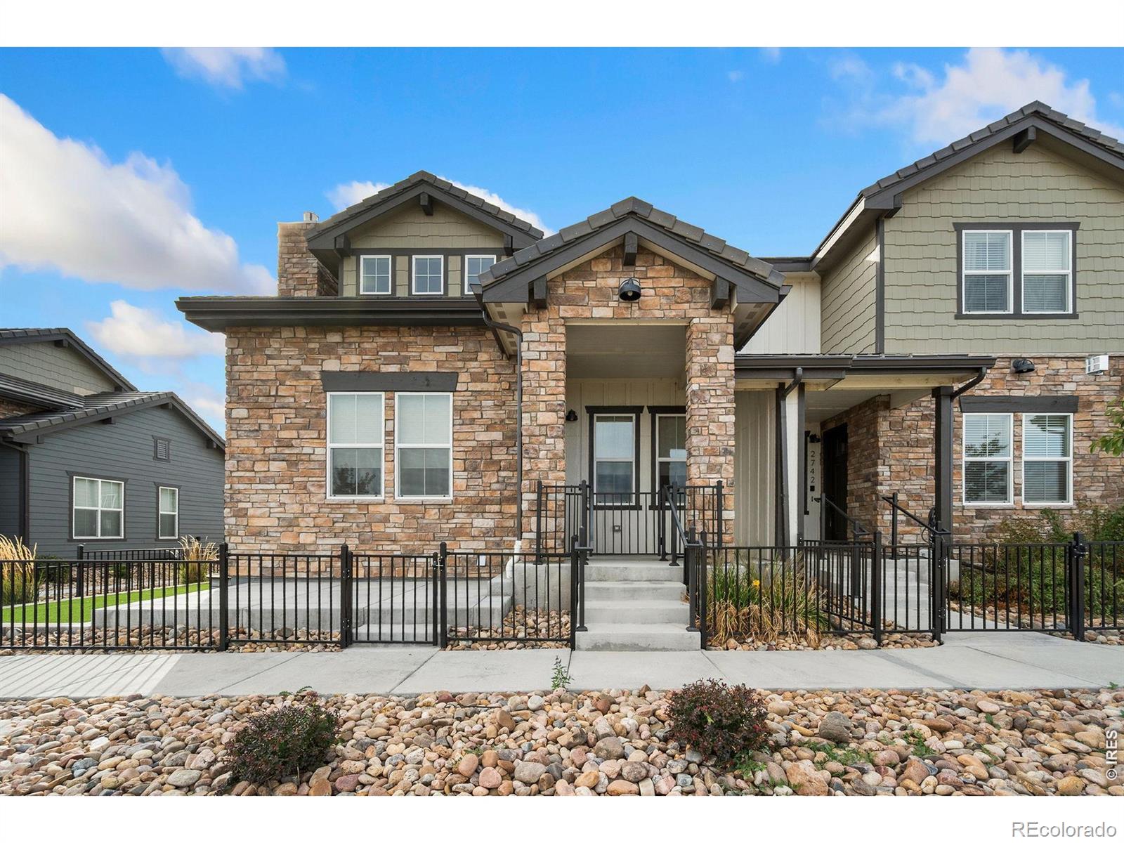 Enjoy low-maintenance living in the sought-after Heron Lakes community at TPC Colorado! This spacious 4-bedroom, 3.5-bath end-unit townhome offers a main-floor primary suite, finished basement, mountain views and thoughtfully upgraded finishes. The bright, open-concept main level features vaulted ceilings, wood-look flooring and a gas fireplace with herringbone tile surround. The kitchen showcases rich cabinetry, quartz countertops, stainless steel appliances, gas range and a striking navy island with waterfall countertops and seating. The main-floor primary suite includes a walk-in closet and private bath with dual sinks and a tiled walk-in shower with bench. Upstairs you'll find two additional bedrooms with mountain views, a full bath and dedicated laundry room. The finished basement provides a fourth bedroom, full bath, second living area and additional storage. Outside, enjoy a fenced patio and side yard with low-maintenance turf, plus an oversized attached 2-car garage. Heron Lakes offers trails, open space and resort-style amenities near Lonetree Reservoir and TPC Colorado's championship golf course. Golf membership is separate. Conveniently located near downtown Berthoud with easy access to Loveland, Fort Collins and the surrounding Northern Colorado area.