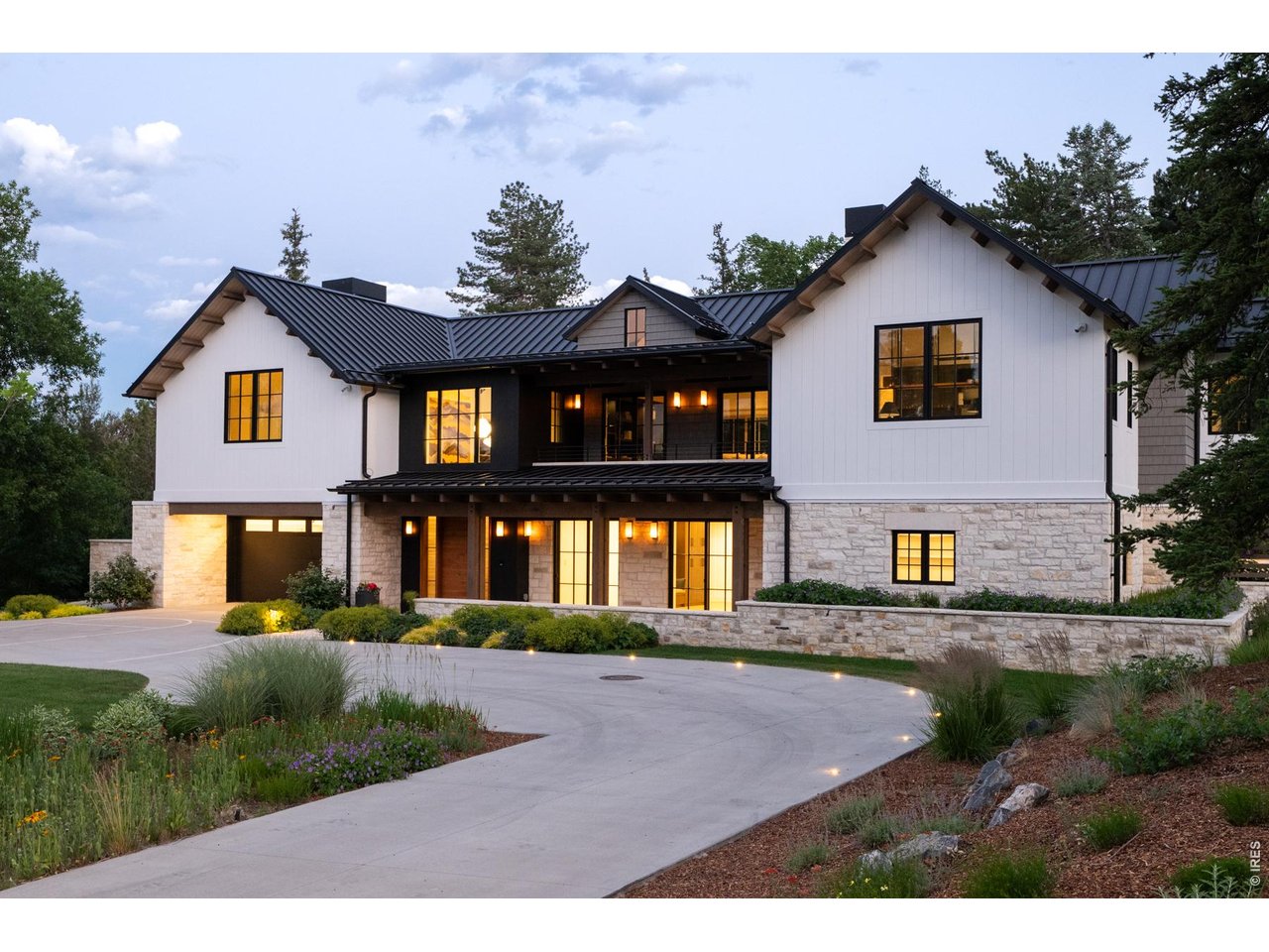 Some homes are built. Others are composed. At 2100 Kohler Drive, architecture, landscape and craftsmanship were conceived as one, creating an extraordinary Boulder residence that would be nearly impossible to replicate today. Designed by Surround Architecture and built by Harrington Stanko, the home pairs hand-cut natural stone, dramatic timber structure, warm wood ceilings and expansive steel-framed glass with an effortless connection to its remarkable setting beneath Boulder's famous Flatirons. Inside, soaring volumes give way to intimate, beautifully detailed spaces. The great room is anchored by a monumental stone fireplace beneath vaulted wood ceilings and exposed beams. A chef's kitchen with oversized island, professional appliances and custom cabinetry flows into the dining area, built-in breakfast nook and fully equipped scullery, while walls of glass open the interiors directly to the gardens. Outside, Marpa Landscape Architecture created a private sanctuary of mature gardens, cascading water, stone terraces and multiple outdoor rooms. A covered dining pavilion with built-in kitchen, expansive courtyard and secluded fire feature extend daily living into the landscape. The primary suite is its own retreat with vaulted ceilings, fireplace, private garden access, spa bath, oversized steam shower, infrared sauna and custom dressing room. Additional spaces include a media room, gym, music studio and recreation areas. Savant automation, solar with battery backup, snowmelt and sophisticated mechanical systems complete a residence where exceptional design is matched by extraordinary livability-minutes from Boulder's best hiking trails, schools and downtown, yet surrounded by privacy and the iconic beauty of the Flatirons.