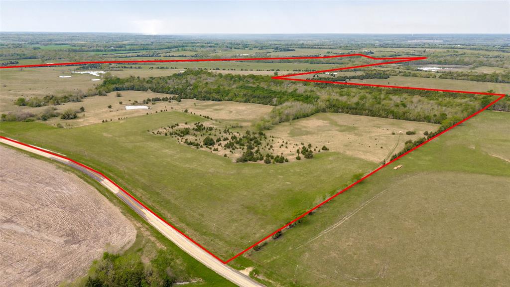 Located just southeast of Roxton, TX, this exceptional 340-acre tract offers a rare combination of agricultural productivity, cattle potential, and outstanding recreational value. With extensive frontage on both paved FM 2675 and County Road 25100, access is excellent, and a 4” water line provided by Lamar County Water Supply runs along the property for future development or ranch infrastructure.

The land features rolling hills that gently transition into over 60 acres of fertile bottomland—ideal for hay production or row crop farming. The remainder of the property supports a solid cattle operation with mixed native and coastal grasses, 7 small ponds, and a larger pond providing ample water sources across the landscape. Approximately 50 acres of mature woods, scattered shade trees, and natural cover create the perfect setting for livestock as well as abundant wildlife.

Cane Creek—with its rock bottom and year-round water—forms a scenic border and serves as a natural wildlife corridor. This area, along with the thick woods, provides ideal habitat for whitetail deer, turkey, and other native species. The property has experienced only low-pressure hunting over the years, and is known for producing large-bodied, trophy-class bucks.

Whether you’re looking for a working ranch, a productive farm, or a recreational getaway with investment potential, this Roxton property checks all the boxes 

Additional adjoining 83.94 acre tract as well as adjoining 43.36 acres also available for a total of 467 more or less acres to secure a sizable piece in Northeast Texas. See MLS 20905933 and 20904868