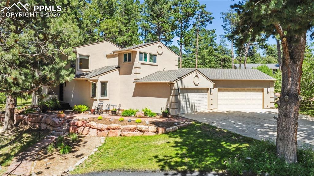 Spectacular Woodmoor property! Nestled on a private, treed lot on a quiet cul-de-sac, this home offers a beautiful park-like setting with rare combo of serene forest and sun splashed green meadows. Step inside to a warm and inviting floor plan with refinished solid oak flooring, new carpet, and high quality upgrades throughout! The spacious yet private living room, sets the tone for relaxing mornings with coffee or a favorite book! The space seamlessly flows into the large family room and a beautifully equipped gourmet kitchen boasting granite countertops, double oven, gas cooktop, Wolf stainless appliances, large center island w/seating, a sunny breakfast nook, large walk-in pantry, and an elegant formal dining room! A granite wet bar with a wine cooler adds a refined touch of luxury to the main level. Embrace peaceful Colorado living surrounded by nature as you step out back, greeted by a stunning rock waterfall/pond-perfect for wildlife watching, & tranquil mornings on your private trex deck with wrought iron railings, and wraparound flagstone patio. Upstairs, the spacious primary suite showcases a newly renovated five-piece bath with marble finishes and a large custom shower, stylish double vanity, large soaking tub, along with custom/extended walk-in closets. A large second bedroom also features its own walk-in closet and beautifully updated 3/4 bath across the hall. The Garden Level Basement expands your living space with an additional Family Room, bedroom/exercise room, large granite sports bar, 3/4 bath, and utility rooms. A newer impact resistant roof, & Milgard Windows add to the home's overall safety/appeal. Park your classic vehicle/toys in the oversized 4 car garage! Ideally located just 1/2 mile from The Country Club at Woodmoor, boasting an 18-hole golf course with tennis/pickleball, gym, pools, dining, etc! You'll also enjoy close proximity to Monument & Woodmoor Lakes, Parks, Trails, & charm of Downtown Monument, w/easy access to I-25 or Hwy 83!