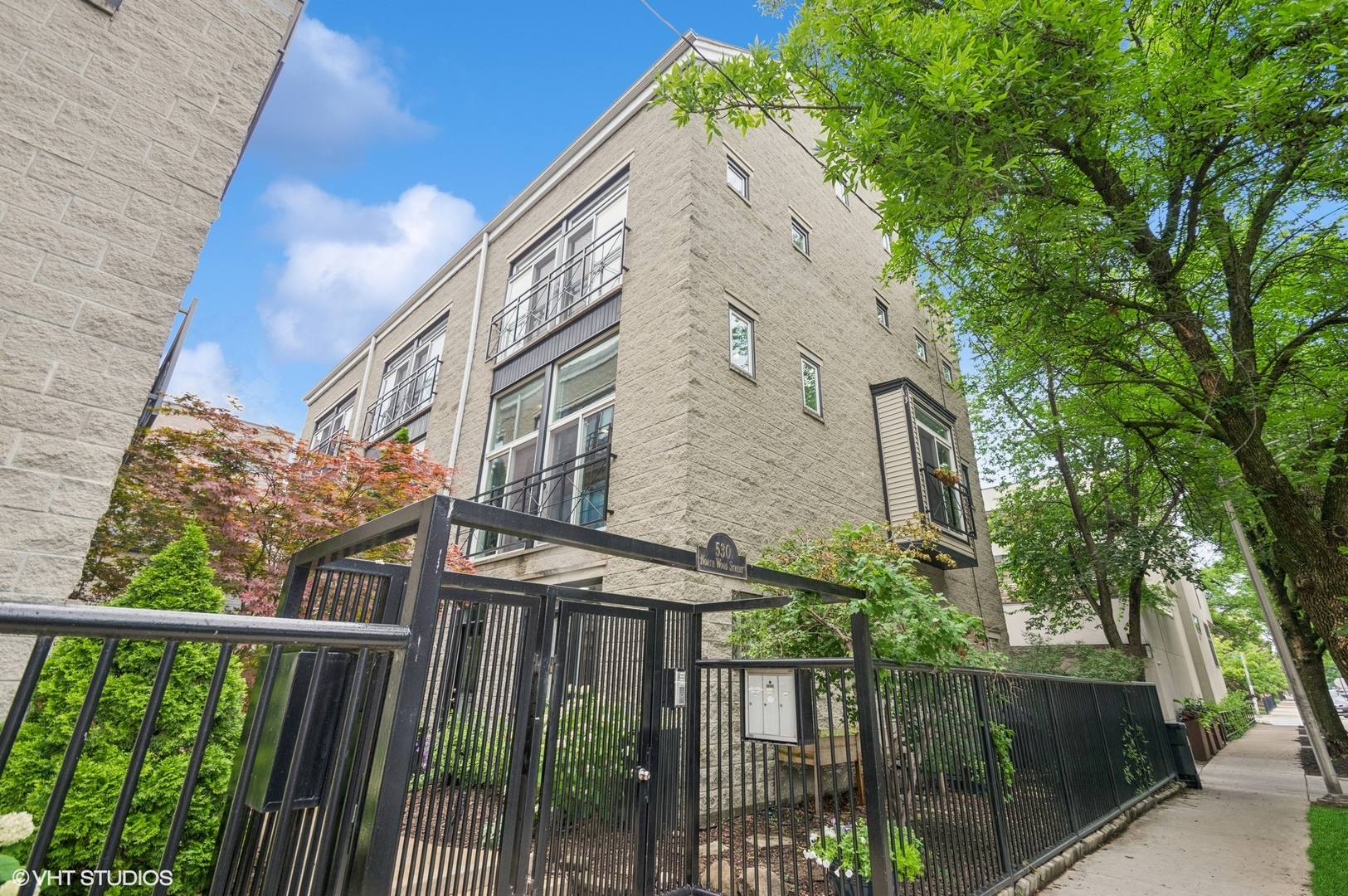Prepare to be impressed where style meets appeal! This desired end unit offers 3 sunlit exposures, 5 Juliette balconies plus no monthly HOA dues! The impressive 19x13 living room showcases a full wall of windows, recessed lighting plus a warm and inviting fireplace flanked by 2 accent windows and built in seating/display areas.  The large, separate dining room overlooks the living rm and is conveniently adjacent and open to the kitchen. Perfect for entertaining or intimate dinner parties.  The upgraded kitchen is a cook's dream featuring quartz counters, beautiful white cabinetry, stainless steel appliances plus a full wall of sliders with stylish transom windows.  The primary bedroom offers an oasis of comfort with a custom walk- in closet plus an en-suite full bath, highlighted by a walk in steam/rain shower, separate tub and double sink vanities.  The versatile 2nd bedroom features it's own, private en-suite bath with walk in shower and upgraded finishes.  Work from home options are available here with the 3rd bedroom/office on it's own level, complete with half bath and French doors that lead to the foyer and 2 car garage.  The top level 19 x17 family room is highlighted by high ceilings, skylights and double sliders that lead to a roof top deck with downtown views.  4 full levels of living space await you with generous room dimensions, rich hardwood flooring throughout, custom millwork and a pleasing color palette. Stylish and tasteful this home will not disappoint.