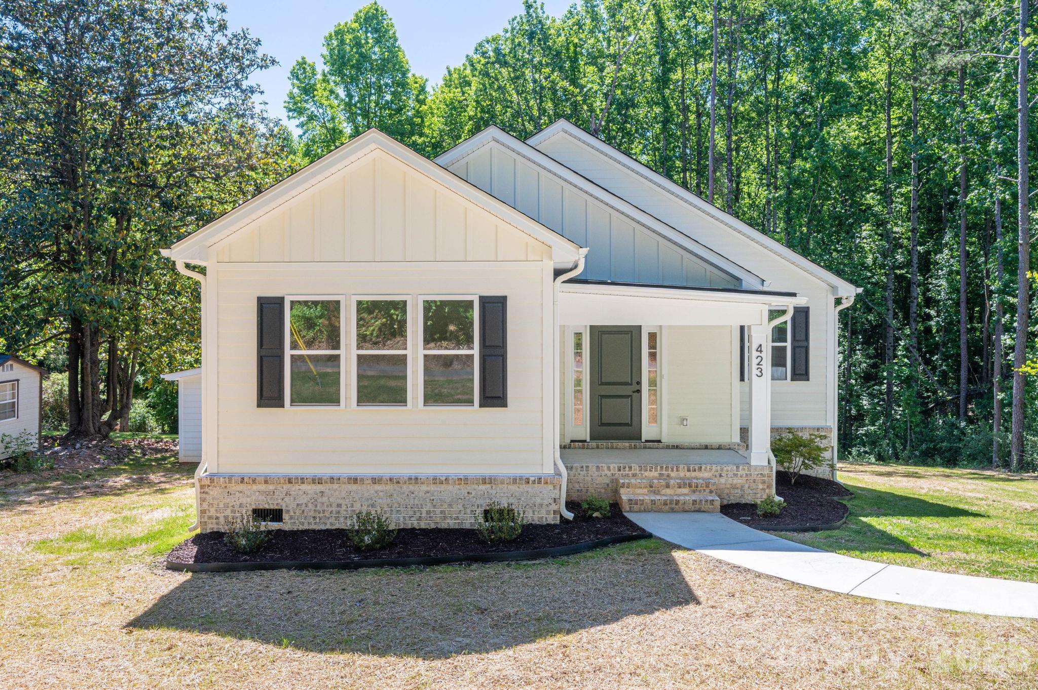 Brand new construction offering comfortable, functional living throughout. This 3-bedroom, 2-bathroom home features an open floor plan with spacious living areas. The large kitchen comes equipped with stainless steel appliances, and a cozy fireplace anchors the living area. Step out to the covered rear porch for easy indoor and outdoor living, whether you're relaxing or hosting. The property also includes a large yard, plenty of driveway parking, and an exterior storage shed for tools, lawn equipment, or hobbies. Come see it today.