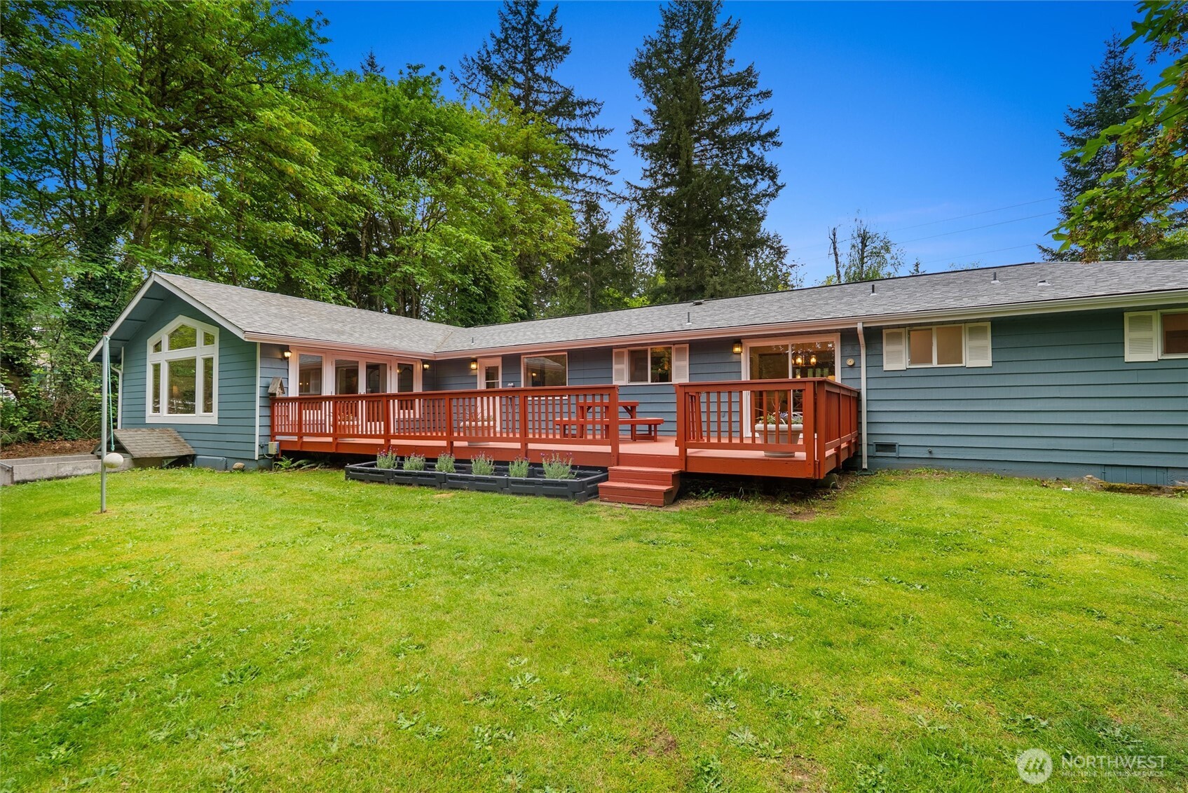 Tucked away on over 2 private acres in Kent, this fully remodeled rambler offers the perfect combination of modern updates, versatility, and peaceful surroundings. Thoughtfully refreshed throughout, the home features stylish finishes, inviting living spaces, and a functional layout designed for both everyday living and entertaining. The main level includes a spacious primary suite along with 3 additional bedrooms and one non-conforming bedroom, while large windows fill the home with abundant natural light, creating a bright and welcoming atmosphere. Enjoy a 790 sq ft finished basement, offering exceptional flexibility with two additional non-conforming rooms, 3/4 bath, and potential for a future ADU setup with kitchen—ideal for multigenerational living, guest space, a home office, workout room, or possible rental opportunity. The expansive 2+ acre property provides room for recreation, gardening, RV parking, hobbies, or future projects, all surrounded by mature greenery for added privacy. A spacious 2-car garage offers ample parking, storage, and workspace. Enjoy the tranquility of acreage living without sacrificing convenience, with easy access to major freeways, airport, shopping, dining, schools, commuter routes, and adjacent access to Lake Young Reservoir trails. A rare move-in ready opportunity offering land, flexibility, and lifestyle.