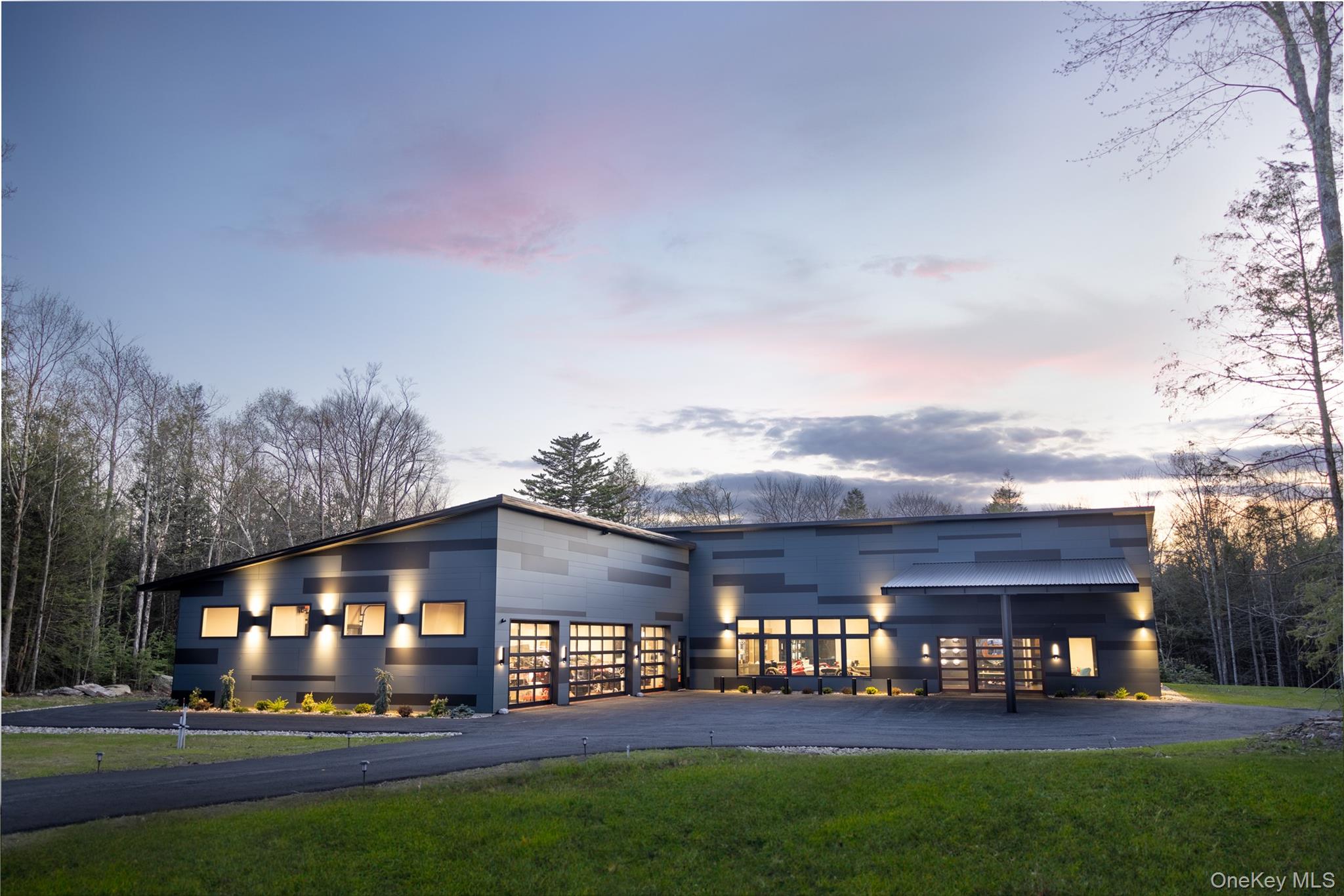 An Exclusive Masterpiece: 97 Serenity Lane, Monticello, NY 12701

A truly rare opportunity has become available within the prestigious, gated Motor Club Estates. This magnificent estate on 5 private acres offers an unrivaled blend of modern luxury, world-class technology, and automotive enthusiast facilities, all housed within an almost 8,000 sq. ft. residence featuring 4 bedrooms and 4.5 baths. No detail has been left untouched in this meticulously curated home.
* also comes with a Gold Membership at the Monticello Motor Club.

Interior Excellence & Technology

Step inside to Italian porcelain flooring and experience a seamless flow enhanced by a Lutron automated lighting system and a whole-house Sonos audio system. The Great Room serves as the ultimate entertainment hub, boasting a breathtaking 149-inch Planar television wall and a sophisticated CertainTeed walnut acoustical ceiling. For the connoisseur, a climate-controlled, 300-bottle glass wine cellar provides a dramatic backdrop for entertaining.

The custom chef’s kitchen features an oversized island with integrated wireless charging stations, perfect for casual gatherings, while the formal dining area centers around a stunning custom 18-person dining table.

A true centerpiece for any motor enthusiast, the home proudly features a full-scale 1:1 Alfa Romeo F1 Show Car display, blending high-octane passion with architectural design.

Uncompromising Comfort & Sustainability

The entire home ensures year-round comfort with geothermal heating and cooling (backed by electrical heat) and luxurious heated radiant flooring throughout. Furthermore, the property operates efficiently with Tesla solar power and backup batteries, providing superior sustainability and peace of mind. Every one of the four bedrooms is a private retreat, featuring its own exquisite en-suite bath.

Outdoor Oasis

Extend your living space onto the spacious covered outdoor patio. This al fresco haven is designed for year-round enjoyment, equipped with automated electric screens, an outdoor television, integrated speakers, and a cozy fireplace. Unwind on one of the three heated stone lounge chairs, offering a spa-like experience under the stars. The exterior is finished with maintenance-free Trespa siding, manufactured in the Netherlands.

The Ultimate Garage & Workshop

For the serious collector or mechanic, the garage is a facility built without compromise. It features a professional-grade setup including an Omer in-ground scissor lift with flip-up jacks, a Hunter tire changing machine, a Hunter wheel balance machine, and two Ingersoll Rand 80 gal air compressors. Utility is maximized with two Nitrogen tanks with hoses, ample tire storage racks, and a power washer with a hot/cold mixing valve. All of this rests on a durable stone hard floor coating, rated for 10,000 psi.

This property is more than a home; it is a lifestyle statement offering technology, luxury, and unparalleled amenities. Private showings are available upon request to qualified buyers.