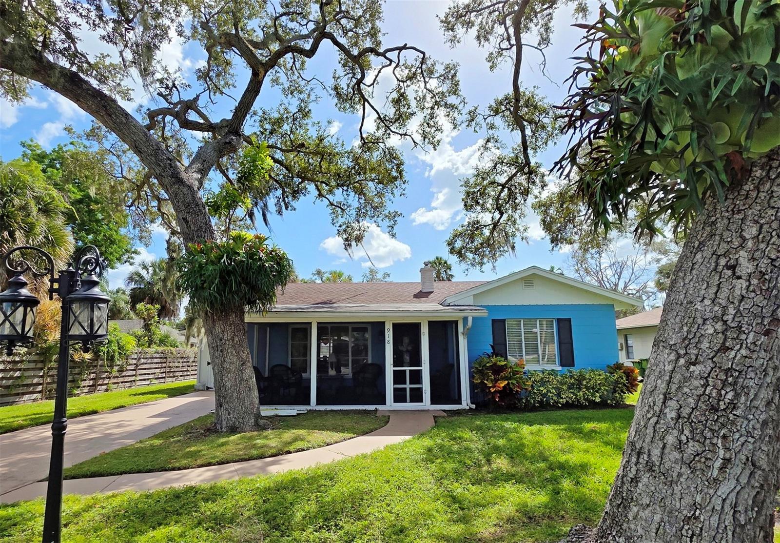LOCATED WEST OF THE TRAIL IN A TROPICAL PARADISE. A charming 3-Bedroom, 2-Bath Cottage in Indian Beach–Sapphire Shores. Discover this adorable Cottage in Indian Beach. WEST OF THE TRAIL. The home has  with spacious master ensuite with a walk-in shower. The 2nd and 3rd bedroom are attached so the perfect solution is make the middle bedroom a bonus room/playroom with a TV and pull out sofa for extra entertaining space in your home but a great overflow for visiting guests. A shared bath with shower/tub combination for your guests.  A warm feeling as you enter into 918 Indiana Ln with laminate comforting wood feeling floors. Enter through the screened in porch to relax and have extra sq ft for your home. The living room flows seamlessly to the dining area off the kitchen with hard surface  counters and generous counter space for cooking your favorite meals. Th kitchen exits to your private paved patio and fenced in spacious backyard for total privacy and to enjoy your outdoor dining or your favorite beverage. The single car garage and closed in laundry area are right off paved patio with table and chairs already there for your convenience.  This sweet cottage nestled in the highly desirable Indian Beach–Sapphire Shores neighborhood of Sarasota! Full of charm and ideally located, this lovely home offers the perfect blend of comfort, outdoor relaxation, and convenient and easy access to several marina's.Enjoy leisurely walks through this beautiful neighborhood, with a designated Sarasota Bay sunset-viewing area just one block away. You’ll also be close to the Ringling Museum of Art, Sarasota Jungle Gardens, and just approximately 2 miles from downtown Sarasota and St. Armand's Circle where you can explore wonderful restaurants, shopping, entertainment, and more. JUST MINUTES TO SIESTA KEY AND LIDO KEY BEACHES.Charming, inviting, and ideally located—this delightful Sarasota cottage is a wonderful place to call home!