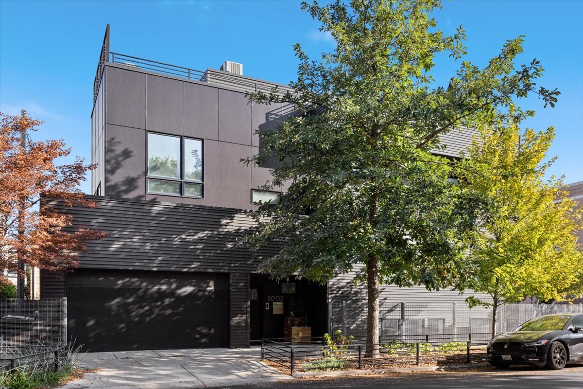 Beautifully modern and architecturally unique single family home in a prime West Town location. This unique floorplan lives extremely gracefully, with large room sizes due to the sculptural steel staircase in the center of the home. The loft-like main level is bright and airy with east and south facing windows. The kitchen is massive with a huge island and built-in dining table. Enjoy high end appliances with abundant counter and storage space. The kitchen overlooks the large family room with a striking tile fireplace wall and dry bar. The primary suite features custom built-in closets, and a large attached bathroom. The bathroom was recently updated with a double vanity and body sprays + rain head shower. The secondary bedrooms share a beautiful Jack and Jill bathroom. All upstairs bedrooms open directly to outdoor spaces. The rooftop deck is stunning with porcelain paver tiles, multiple seating areas, and a full outdoor kitchen with skyline views! The lower level features a media room with a built in projector screen and another bedroom and full bathroom. The cork floors add a modern flair. The attached 2 car garage with a curb cut offers extra parking and opens directly inside to the entryway. Walkable to dining and bars along Chicago Ave and with easy access to downtown and the highway and more, this location is incredibly convenient!