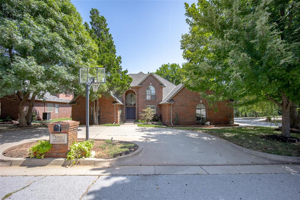 You will fall in love with this CORNER LOT on a 1/3 ACRE that feels private and wooded. The exterior has an executive feel with a CIRCLE DRIVE allowing for plenty of parking. 

The DOUBLE front DOORS both open to make moving a breeze. Inside
you are greeted with a large open living space with WINDOWS lining the back wall giving you an INCREDIBLE VIEW. This space connects to another living area that shares a FIREPLACE and has built-ins. The kitchen is spacious with DOUBLE OVENS and BRAND NEW QUARTZ tops and backsplash with PLENTY OF STORAGE. The laundry room sits next to the kitchen and has extra pantry storage. There is a large FORMAL DINING at the front that could double as an office space. 

The half bathroom sits conveniently downstairs for your guests. The primary SUITE is a dream with SO MUCH SPACE that you could have your
own living area by the FIREPLACE and includes an exterior door leading to a PRIVATE PATIO. The bathroom is huge with separate vanities and a LARGE WALK IN CLOSET. 

While the primary is downstairs, the other 3 guest rooms are upstairs with all rooms being spacious. One guest room has an attached full bathroom and the other 2 share a connecting bathroom. Lots of STORAGE upstairs with cabinets and closets. 

The backyard is INCREDIBLE with a large covered patio, deck and mature trees. There is a nearby creek you can see from the patio. BRAND NEW RETAINING WALL just installed. The 3 car garage is oversized with plenty of space. The entire bottom floor has just been freshly painted. Come see this one today!