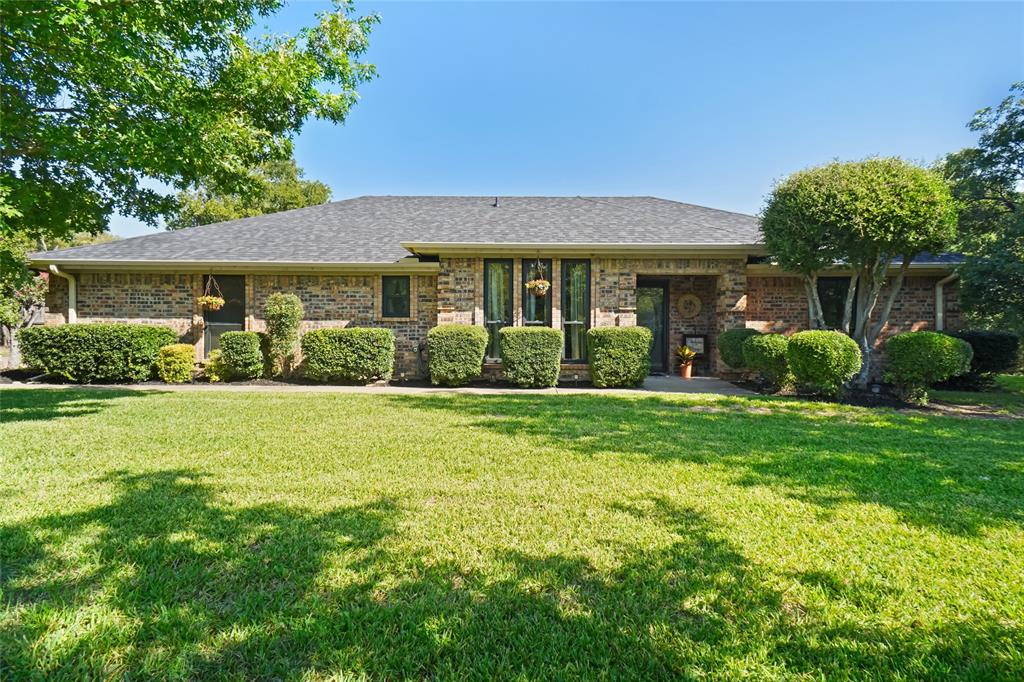 Welcome to this beautifully updated brick home that combines timeless charm with modern conveniences. This charming home features numerous updates including new roof, new windows through out, new interior doors, new stove with double oven, travertine flooring, and imported granite countertops. Spacious living area with vaulted wood plank ceiling, exposed beam and brick fireplace creates a warm and inviting atmosphere, perfect for gatherings. The kitchen is designed with both style and function with stainless steel appliances, imported granite countertops, breakfast bar and two dining areas. Enjoy the desirable split bedrooms with a huge primary bedroom suite offering a bathroom retreat with separate shower and relaxing jetted tub. Step outside to your own outside oasis complete with sparkling pool with diving board, spa, and stone accents ideal for entertaining or unwinding. Mature trees and manicured landscaping add to the curb appeal and privacy on half acre lot. Additional detached garage that could be a great workshop or used in various ways. Move in ready and perfect for modern living with timeless style. Great location with easy access to Highway 199, or 820.
