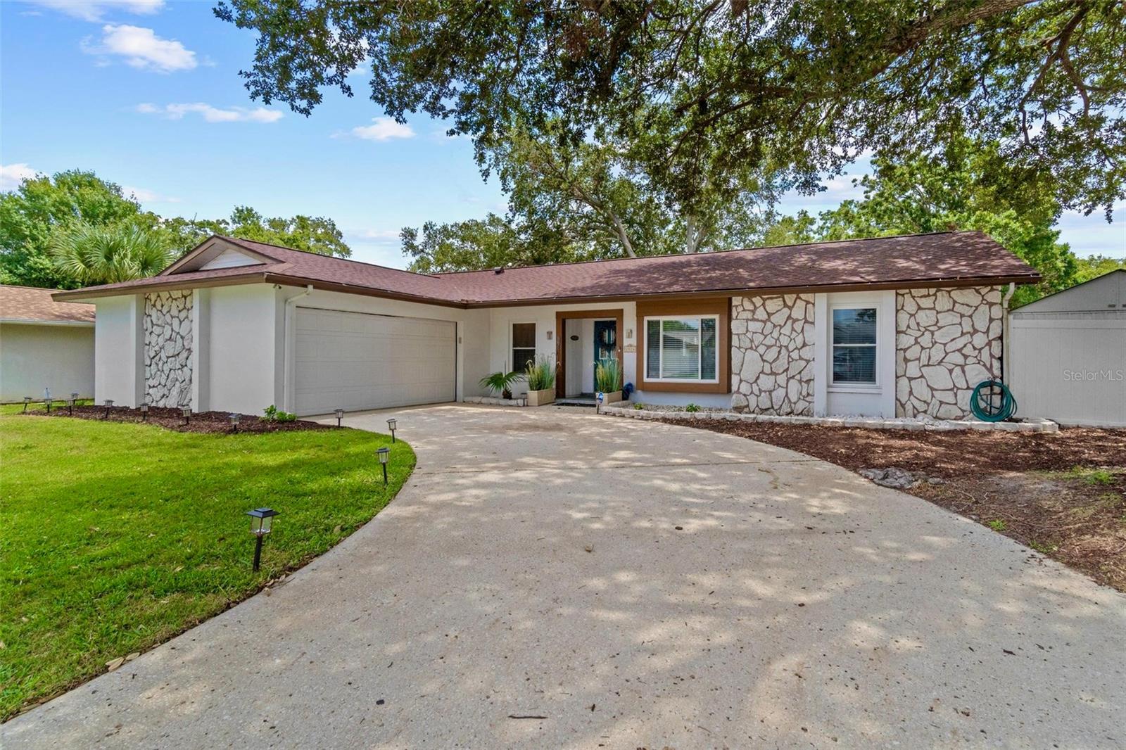 Welcome to your dream pool home in the sought-after Rustic Oaks community, perfectly situated within the highly desirable Palm Harbor University school zone. This immaculate, fully remodeled residence impresses from the moment you arrive, boasting gorgeous curb appeal with stone accents, fresh landscaping with in-ground irrigation, and a side-load garage. 

The home is located on one of the highest streets in the area – 65 feet above sea level in flood zone X – providing peace of mind that you’re high and dry, with no flood insurance required.

Step inside to discover a thoughtfully designed open-concept floor plan featuring a spacious great room layout with soaring cathedral ceilings, a cozy wood-burning fireplace, and split bedrooms for privacy. The gourmet kitchen is truly the heart of the home, showcasing elegant Thomasville custom cabinetry, granite countertops, a brand-new island, beverage station, and top-of-the-line Samsung Smart Hub stainless steel appliances – including a French door smart refrigerator and double oven range.

Quartz crystal chandeliers accent the expansive living and dining areas, perfect for entertaining. The primary suite is a peaceful retreat with a large walk-in closet and luxurious en suite bathroom. Additional bedrooms are generously sized, offering flexibility for family, guests, or a home office.

Enjoy resort-style living in your private backyard oasis featuring a screen-enclosed lanai with light travertine tile, a stunning temperature-controlled saltwater pool, and a brand-new paved patio area – ideal for outdoor dining and entertaining under the Florida sun.

The fully automated smart home system includes a Ring doorbell camera, Honeywell Wi-Fi thermostat, ADT Pulse security system with front and backyard cameras, and hurricane-impact windows and sliders (installed 2012, lifetime warranty).

Recent updates provide peace of mind and modern comfort, including a new roof (2023), electrical panel (2016), Tesla/EV charger, new water softener salt system (2022), and high-efficiency Thermau heater with Pentair pool equipment and rain monitor sensor.

The upgraded garage adds 400 sq ft of heated space – perfect for an office, gym, or flex space – with a new split A/C unit with heat, a new app-controlled garage door opener, and new attic.

And the location can’t be beat – just 5 miles from the beach, 2 miles to Ozona, 30 minutes to Weeki Wachee, and close to downtown Palm Harbor, Safety Harbor, St. Pete/Clearwater Airport, and the new Trader Joe’s.

This home offers luxury, comfort, and security with no flood insurance required – and even stays powered during storms thanks to newly upgraded electrical lines. Schedule your private showing today and come experience the best of Palm Harbor living.