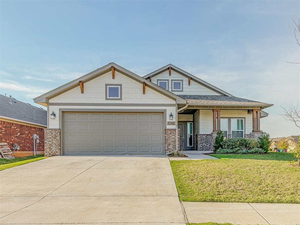 SELLER OFFERING 2-1 INTEREST RATE BUY DOWN WITH PEFERRED LENDER. This stunning Craftsman style home comes with a nice-sized covered front porch and back patio overlooking a fully fenced yard! Inside lies an open concept layout with lovely wood-like tile flooring throughout the living space. The split plan allows distance between the primary suite and secondary beds/bath. The kitchen boasts stainless appliances with a gas cook range, quartz counters, a breakfast bar, and large window for that added natural light! The primary suite comes with double vanities, large walk-in closet, as well as a tile-surrounded soaking tub and stand-up shower! The Featherstone neighborhood amenities include a playground and splashpad for outdoor enjoyment!