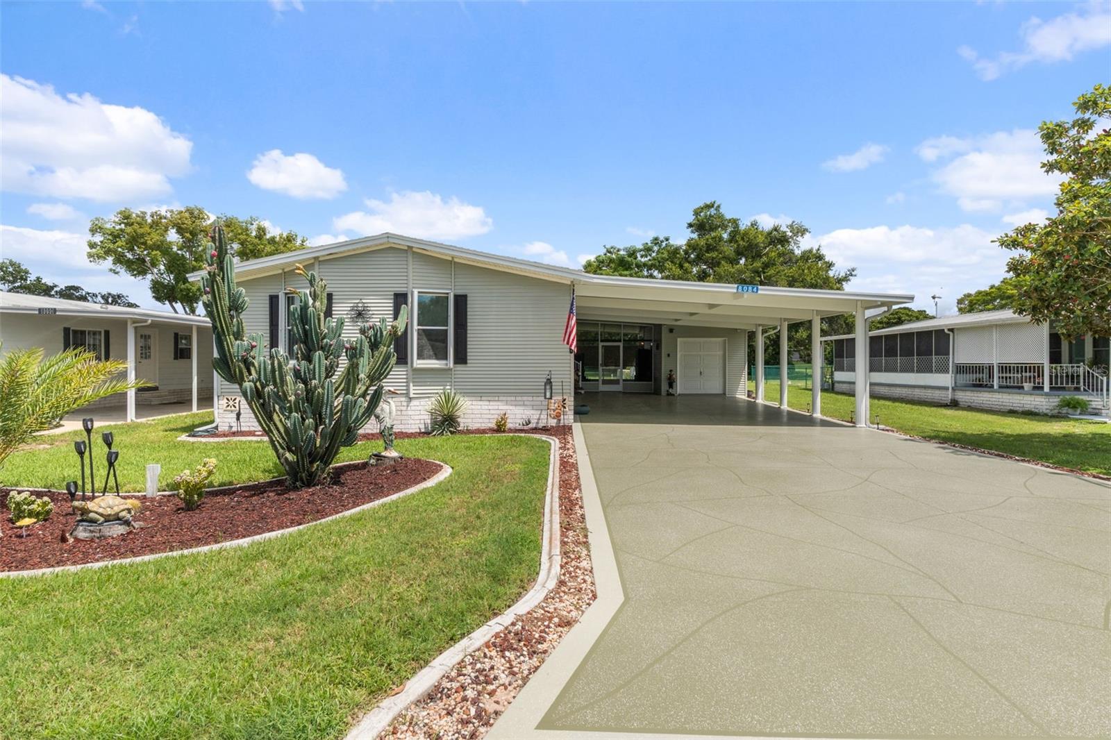 This beautifully updated 1890 square foot 2+ Bed 2 Bath GOLF COURSE home on the #11 Tee has so much to boast. OPEN FLOOR PLAN & HIGH CEILINGS with a bedroom-sized FLEX ROOM/OFFICE that has a French door entry and built in office cabinets. Enjoy your morning coffee in the large sunroom with a golf course view across back of home. The spacious ISLAND KITCHEN offers solid surface countertops and like new appliances. This lovely home offers a master suite with a full length closet and loaded master bath that features a dual vanity, garden tub, and a newly finished custom tile shower. When you are ready to spend time outdoors you can play with with pets in your FENCED YARD or get out of the sun and sit in the extra large LANAI. Hurricane Shutters and Tinted windows. Keep your golf cart or trike in you cart garage/utility room (w/overhead door opener) - Extra large parking area.