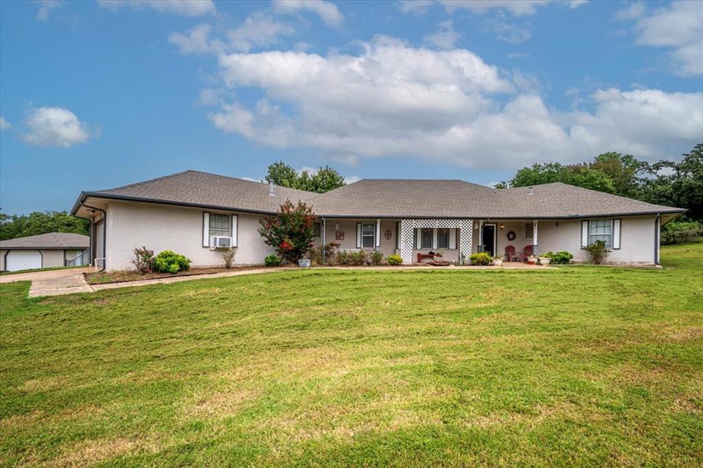 Beautiful wooded 2.20 Acre Property near I35 & Waterloo with a spacious 2463 square foot home and 2 shops! Just 1/2 mile north of Waterloo off Sooner Road. This property is amazing! The home was built in 1978 as a four bedroom, three bath Mother-in-Law plan. Formal living room and dining room. Spacious Den has wet bar, two built-in bookcases and a huge fireplace. Kitchen has a double oven, solid oak cabinetry, built-in desk and hutch and a spacious pantry. The adjoining breakfast room looks out to backyard teeming with abundant wildlife. Primary bedroom has been opened up to adjoining bedroom to form a huge master suite.  Bedroom could be easily converted back to a 4th Bedroom.  All bedrooms have walk-in closets. Exceptionally large utility room, dryer connections for electric or natural gas and room for a freezer. Nice sunroom to just sit and relax, watch the deer and numerous wildlife play. The property boasts a HUGE 30x70x14'tall super clean SHOP with 220 power, big enough for the largest RVs plus all of your other toys, a car enthusiast paradise, 13ft overhead door with opener. Inside the shop, your 10'x20' man cave (office) already has rough in plumbing for half bath and kitchen. Additionally, a 2nd Workshop, 20'x30', also with 220 power. Perfect for woodworking, lawn equipment, boat storage, you name it! The 8'x12' garden shed also has power and concrete floor. Of major significance, major mechanicals already updated: Roof 2019, Both HVAC units(zoned) replaced 2017, water heater Jan 2023, Dishwasher Jan 2023, water well pump was replaced April 2014, updated pressure tank.  All at a GREAT VALUE and location, quick access to I35 and East Edmond shopping! NO HOA! Livestock permitted. $200 annual road maintenance fee. Property is priced to sell.