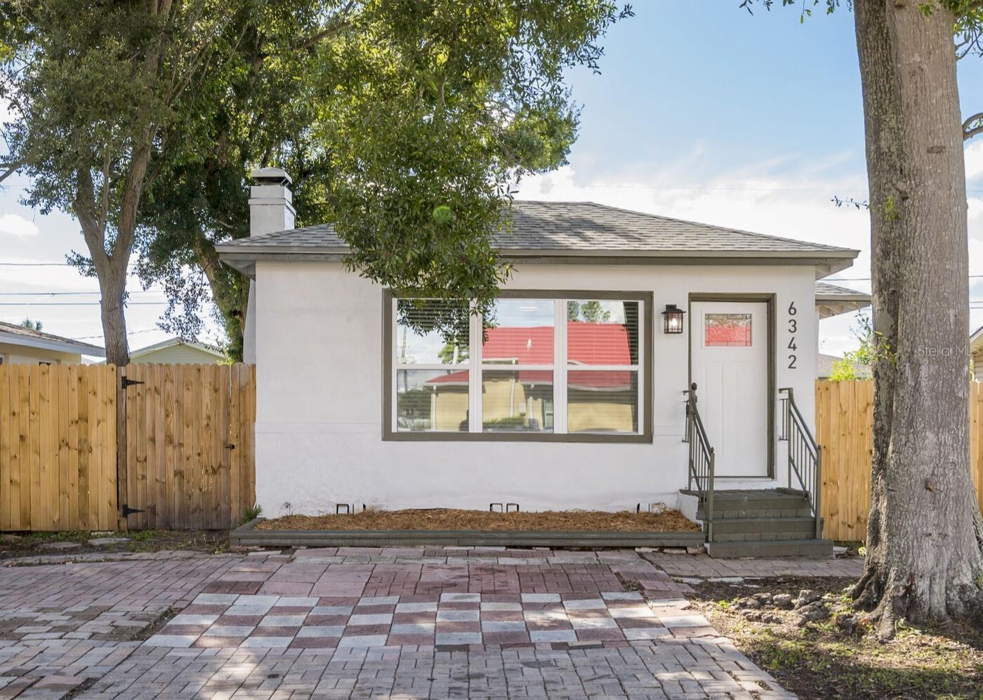 Now on the Market!! Charming Bungalow Style home-- this 2 bedroom, 1 bath blends vintage character with a clean, classic appeal.  It has been modernly updated with a brand new roof and privacy fencing, great for pets and backyard entertaining!  The kitchen has been newly renovated with new shaker style cabinets and black matte hardware, slow close drawers, solid stone quartzite countertops and a new stainless appliance package to include a French door bottom freezer fridge, new range with the upgraded convection fryer oven feature, a matching microwave range hood and dishwasher.  The bathroom has marble tile floors, subway tiled shower to the ceiling and a deep tub to enjoy!  This home has a spacious, open floor plan-- the new light laminate flooring laid throughout creates a nice seamless overall flow. The beautiful living room and dining room windows are large, letting such quality natural light in, easily brightening the entire home.  There is an enclosed, screened-in porch off of the kitchen that lets so much natural breeze in too, great for just relaxing in and enjoying our Florida evening weather!  Located in Pinellas Park close to the 66th St N artery that leads north to the main Park Blvd corridor going east to I-275 leading to the rest of Tampa Bay or west to our gorgeous local beaches!!  This home is not in a flood zone and will not require flood insurance.