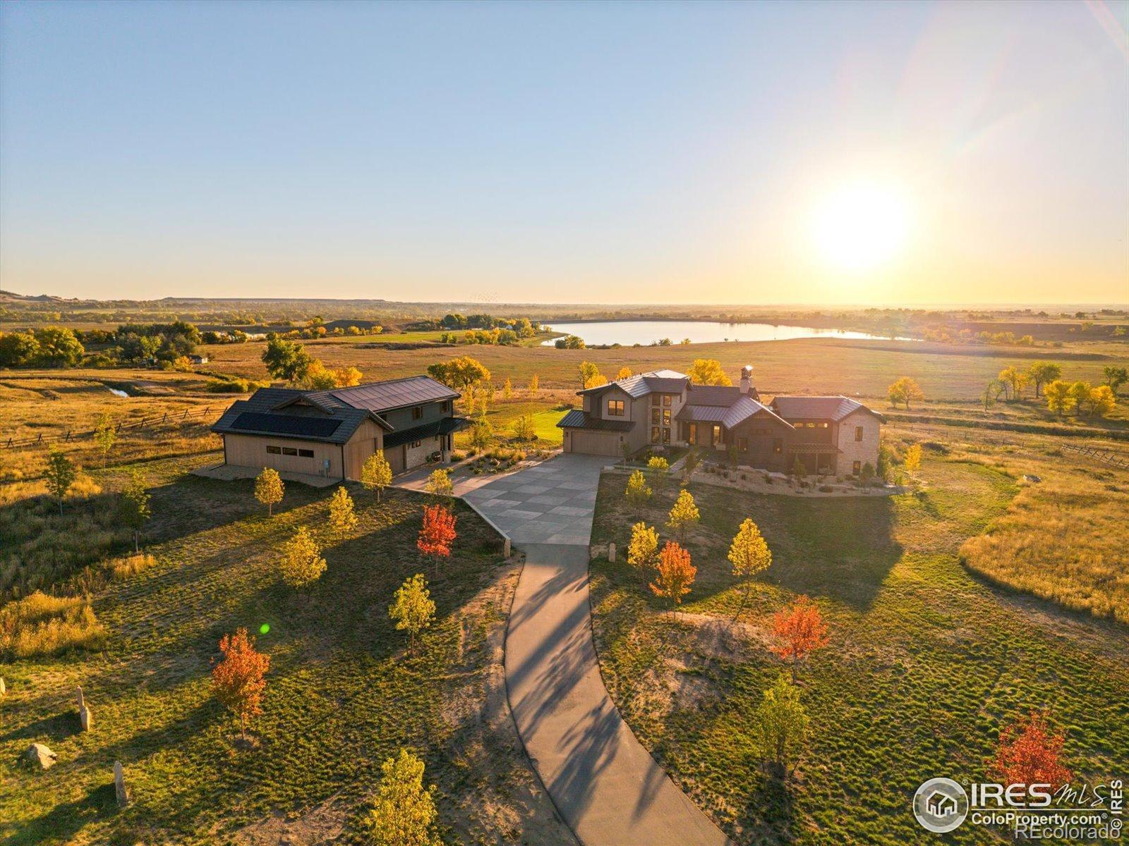 Welcome to the Net Zero Sanctuary at Caribou Springs Ranch, Designed by Whitten Design Group and Built by Ted Stringer with Stringer Construction, this home is a 7239 sq ft architectural masterpiece set on 5.4 acres. This estate offers 2 primary main floor suites, totaling 6 bedrooms, 7 bathrooms, plus a 2862 sq ft accessory building with its own bath and RV garage + 2 car garage. Features include a two-story glass hallway, oversized & accordian windows, expansive doorways and floor-to-ceiling glass in the primary suite. A 13-foot ceiling gym 17x22 ft room, connects to a healing spa with a steam shower/cold side & healing infrared sauna. The chef's kitchen showcases high end appliances, a 16-foot waterfall island with 3-inch Lincoln Gold countertops, complemented by a hidden scullery. In the walk out basement full of entertainment, there's an indoor/outdoor bar, a speakeasy-style entry which leads to a soundproof music studio or retreat. Built within the coveted gates of Caribou Springs Ranch, this architecturally stunning home offers privacy, serenity, and direct access to the community's extensive ~5 miles of private trails and 700+ acres of open space & Foothills Reservoir overlook. Perched below the rolling foothills and overlooking a private reservoir, the home is a sanctuary designed for today and built for tomorrow. Amenities include a clubhouse with pool, hot tub, tennis, pickleball, basketball, and on-site horse boarding, all minutes from Boulder, Lyons and Longmont.