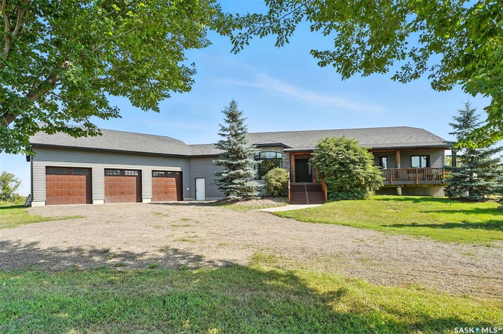 Just south of Vanscoy, and only a short drive from the city, this stunning 2,514 sq. ft. custom home sits on 8.86 acres in a beautifully mature yardsite. Designed with ease of living in mind, it combines rural tranquility with modern luxury—perfect for those looking take a break from the city without sacrificing comfort and quality.
The main floor offers true one-level living with 3 spacious bedrooms and 3 baths, including a spa-inspired ensuite with a custom tile shower and jacuzzi tub. Wide 4-ft hallways, solid pine doors, and thoughtful layout make the home easy to move through, while large windows fill the space with natural light. A cozy wood-burning fireplace framed in granite stone with a live-edge mantle brings warmth and charm.
A chef’s kitchen awaits with cherry wood cabinetry, quartz countertops, and high-end appliances including a Thor 6-burner gas range, Wolfe hood fan & Miele dishwasher. The oversized laundry room provides abundant storage and organization, keeping daily routines hidden and stress-free.
The ICF basement with 9-ft ceilings is nearly complete and ready for your personal touch—family recreation room, home theatre, fitness space, 2 more bedrooms & bathroom. In-floor heating lines are already in place should you prefer a radiant heat.
Outdoors, enjoy expansive front and back decks with timber accents. A luxury saltwater hot tub invites you to unwind, and a convenient dog run right out the back door makes life easier for pet owners.
The oversized triple-car garage provides plenty of space for any need. A large barn adds versatility—equipped with furnace, water, kitchen, bath, and loft with bedrooms and a family room. It’s perfect for extended family visits, ranch hand, or hobbies, with the option to convert for animals if you choose.
Additional energy highlights include triple-pane windows, spray foam insulation for efficiency & upgraded fixtures.
Create your legacy here—where comfort, practicality, and rural beauty come together.