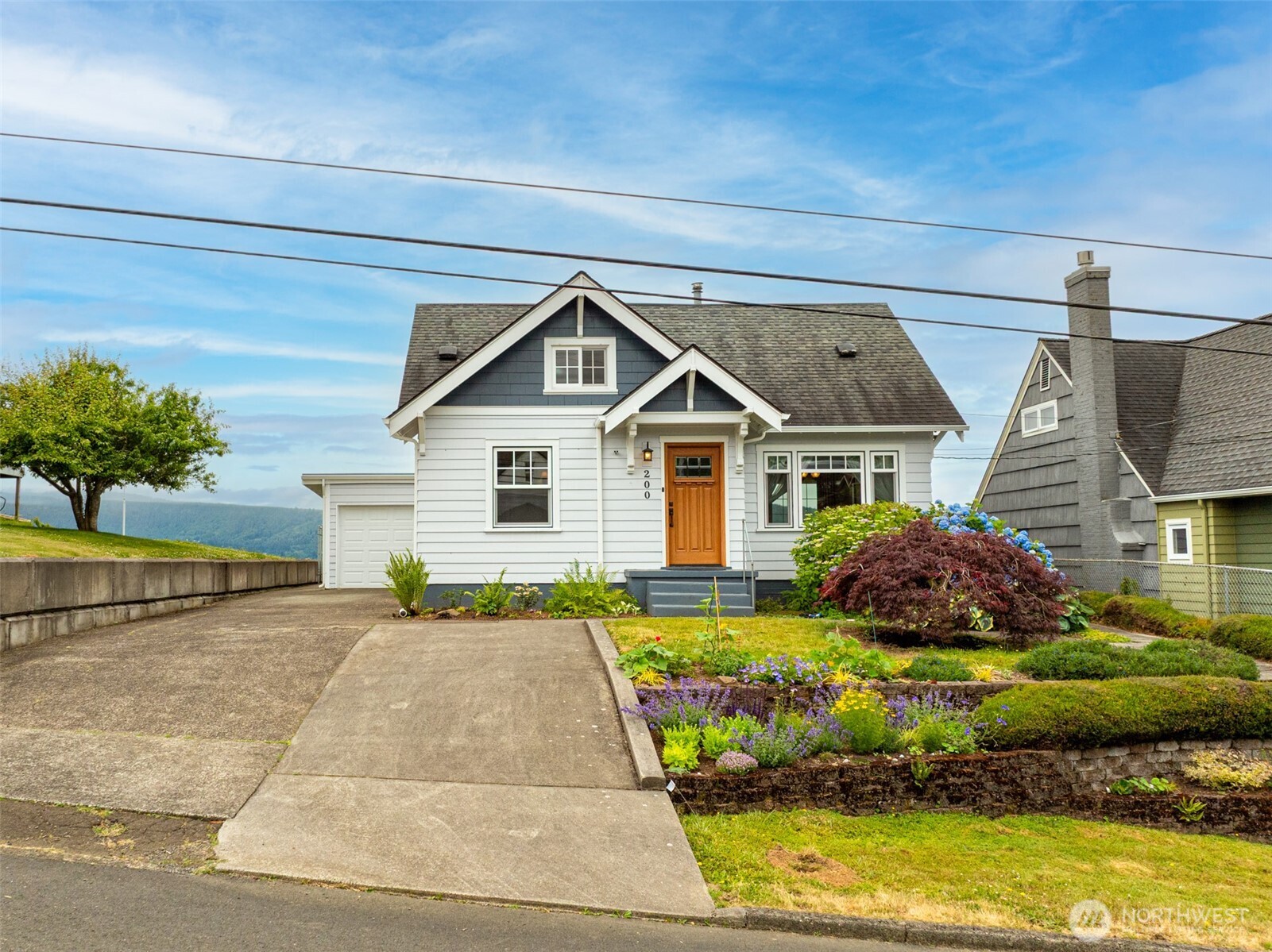 Perched above the Columbia River with sweeping, unobstructed views, this timeless 1920 four-bedroom, two-bath home blends vintage charm with thoughtful care and updates. Step onto the second-story porch and soak in the beauty of passing ships, stunning sunsets, and the peaceful rhythm of the river. Inside, you’ll find character-filled spaces, original details, and abundant natural light. The spacious basement offers bonus space for storage, a workshop, or creative use. Outside, the beautifully maintained gardens in both the front and backyards create a peaceful oasis of color and privacy—perfect for entertaining, relaxing, or cultivating your green thumb. Don’t miss your chance to own a piece of history with unbeatable views!
