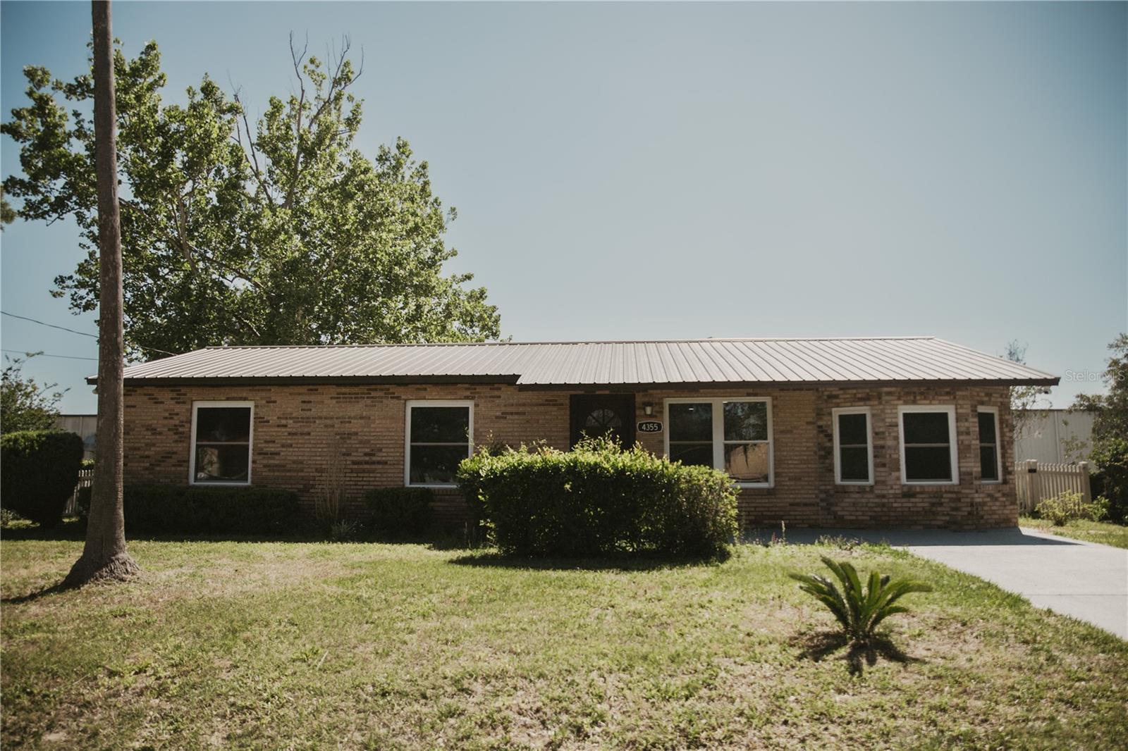 One or more photo(s) has been virtually staged. RENOMVATED and MOVE-IN READY! A Pristine, Durable Blank Canvas. Rare opportunity to own a fully updated brick home on a generous 0.29-acre lot in West Ocala. This 3-bedroom, 2-bathroom residence has undergone a total transformation, boasting a sleek, monochromatic modern interior. Highlights include a stunning new kitchen with shaker cabinets, quartz counters, full stainless steel appliances, a striking geometric backsplash, and a huge peninsula bar perfect for gathering.Low-maintenance gray LVP plank flooring runs throughout, paired with fresh paint, modern recessed lighting, and all-new interior and exterior doors. Key structural assets remain, including a sturdy metal roof and an oversized 4-car carport. Located in the Westview subdivision with no HOA fees, this property provides the freedom and style you’ve been searching for. Just minutes from major shopping, schools, and the World Equestrian Center. Come see the stunning result of this thoughtful renovation!