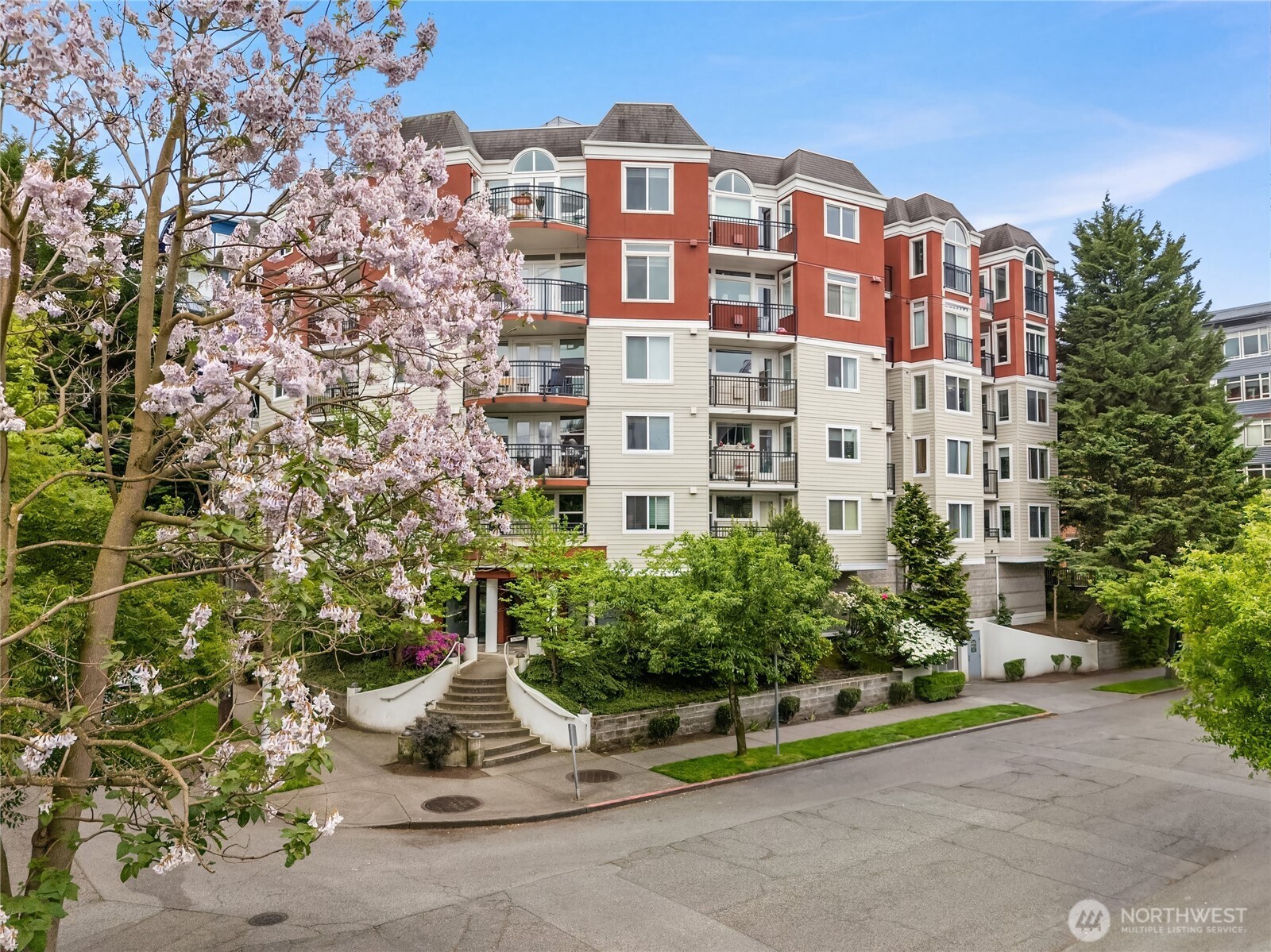 Elevated Capitol Hill living with partial Puget Sound views and beautiful western light, this stylish 2bd+1.75ba condo offers a spacious open-concept layout with generous living areas and a comfortable sense of scale throughout. Thoughtfully updated with brand-new carpet, fresh designer paint, updated trim and doors, quartz bath surfaces, tiled bath flooring, and custom kitchen bar seating. Storage is well-appointed with three closets, including a generous walk-in closet for added convenience, plus a secured storage space in the garage.Enjoy charming neighborhood streetscape views from the bedrooms and unwind on the stunning rooftop deck featuring panoramic city, lake, Sound, and sunset views. Additional highlights include a gas fireplace, two private balconies, and TWO secure garage parking spaces. Exceptional in-city living with a Walk Score of 96, just moments from light rail, Broadway, restaurants, cafés, shopping, and Downtown Seattle. Easy access to I-5 and SR-520 makes commuting to the Eastside effortless.